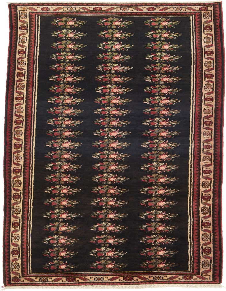 A 10 ft black wool runner rug with a traditional botanical floral pattern and tribal borders, ideal for hallways.