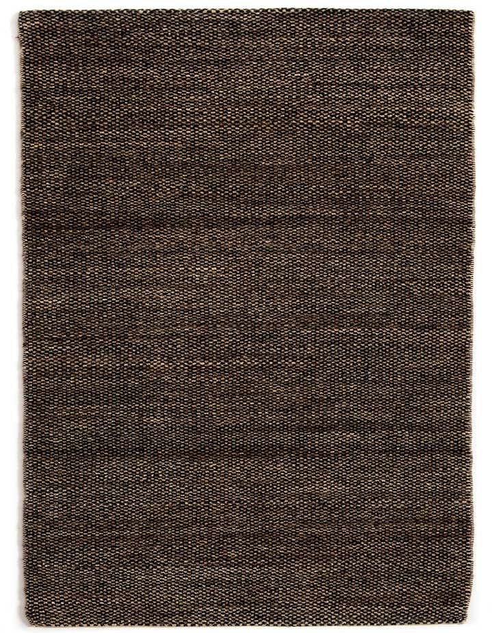 A close-up view of an 8 ft runner rug from the Rugs.com Juma Collection, featuring a textured black and dark brown woven pattern.