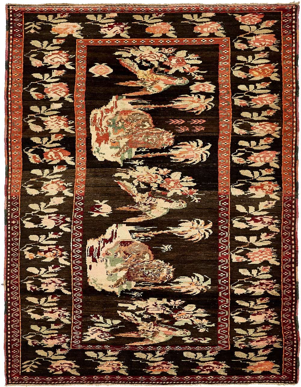 A 9 ft runner rug with a dark brown background, featuring a botanical and tribal pattern in shades of cream, pink, and green, with a red border.
