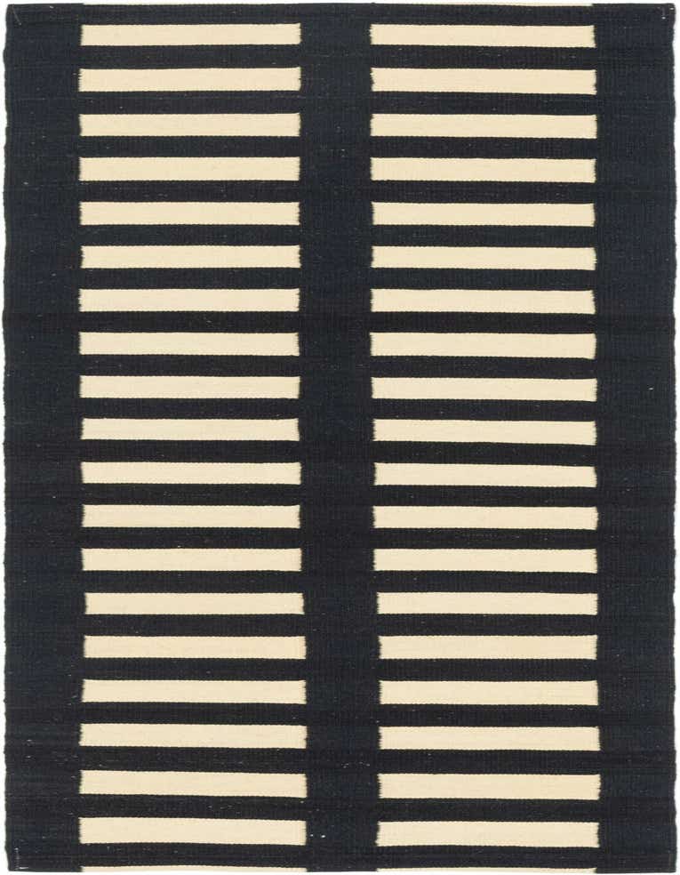 A 7 ft runner rug in black and cream with a modern tribal stripe pattern, ideal for a hallway.