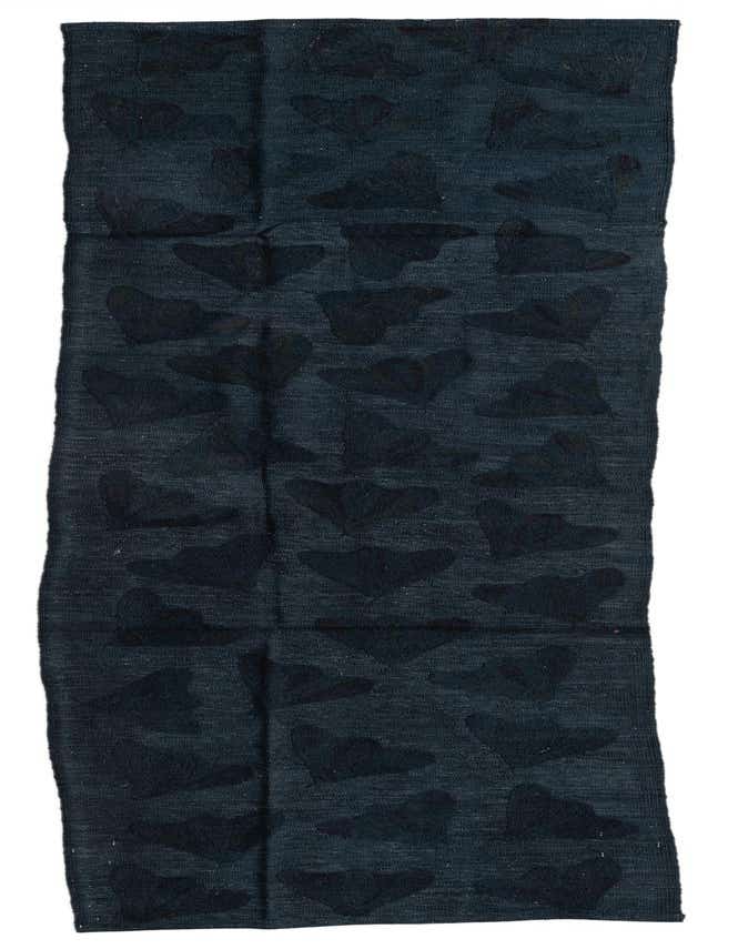 A 9 ft runner rug from the Kilim Suzani collection, featuring a dark black background with subtle black abstract tribal patterns, ideal for a hallway.