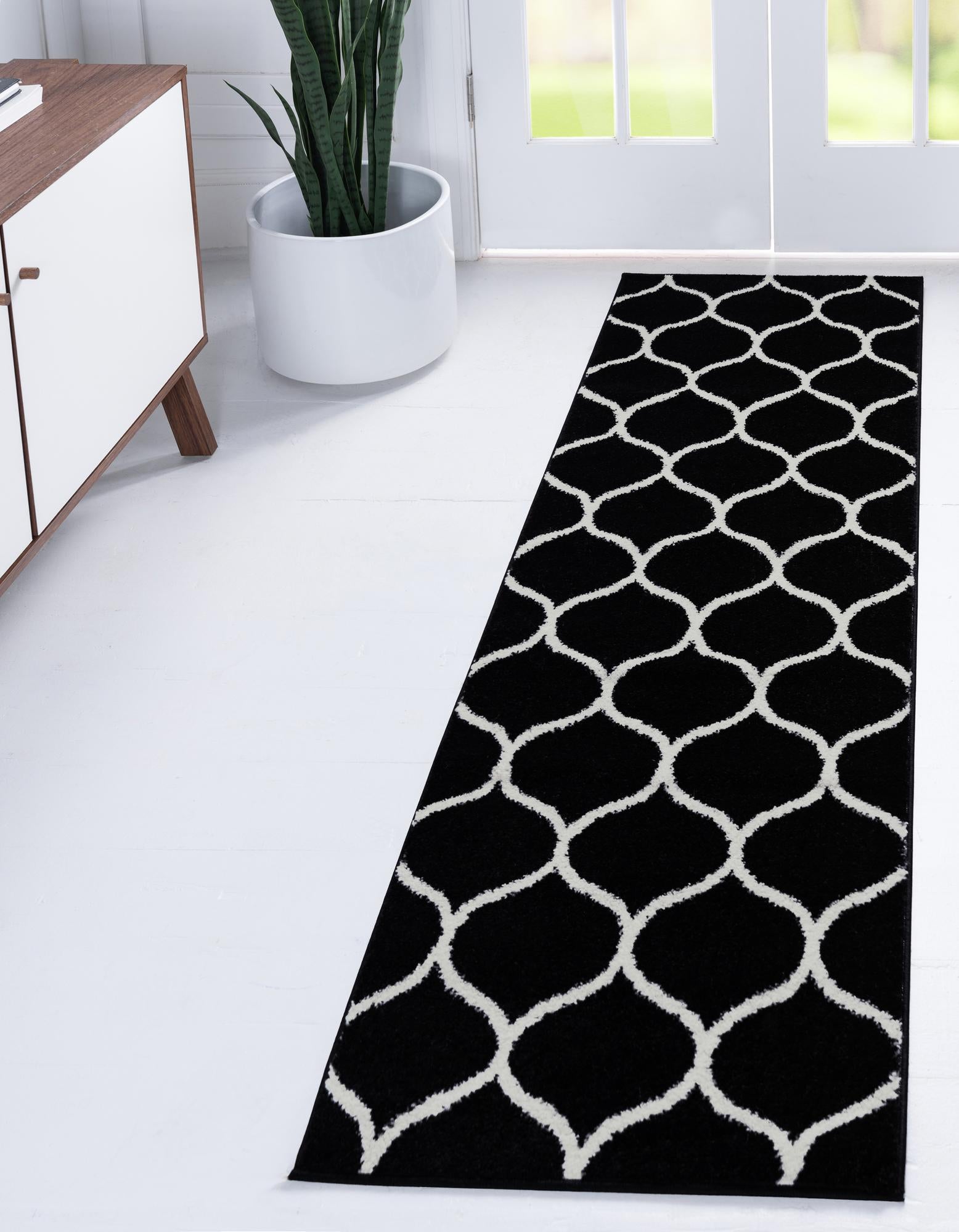 A black 6 ft runner rug with a repeating off-white modern trellis pattern, suitable for a hallway or kitchen.