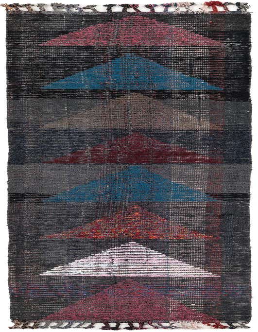 A 10 ft runner rug with a black background and colorful tribal geometric patterns in pink, blue, and red, featuring a shag pile and decorative tassels.