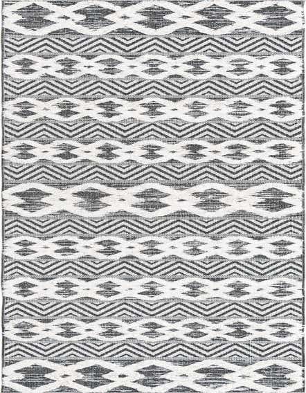 A 12 ft runner rug from the Sabrina Soto Casa collection, featuring a black and white tribal pattern with textured geometric and chevron designs, ideal for a hallway.