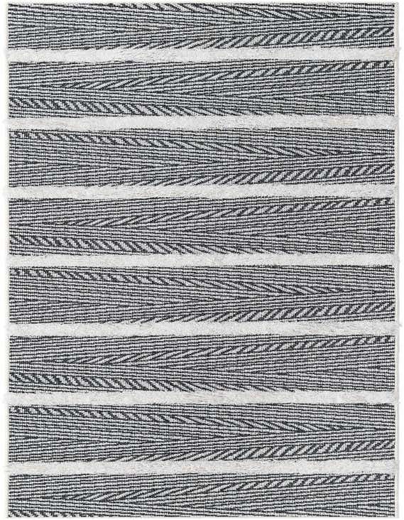 A black and white modern striped runner rug with textured high pile accents, perfect for a hallway.