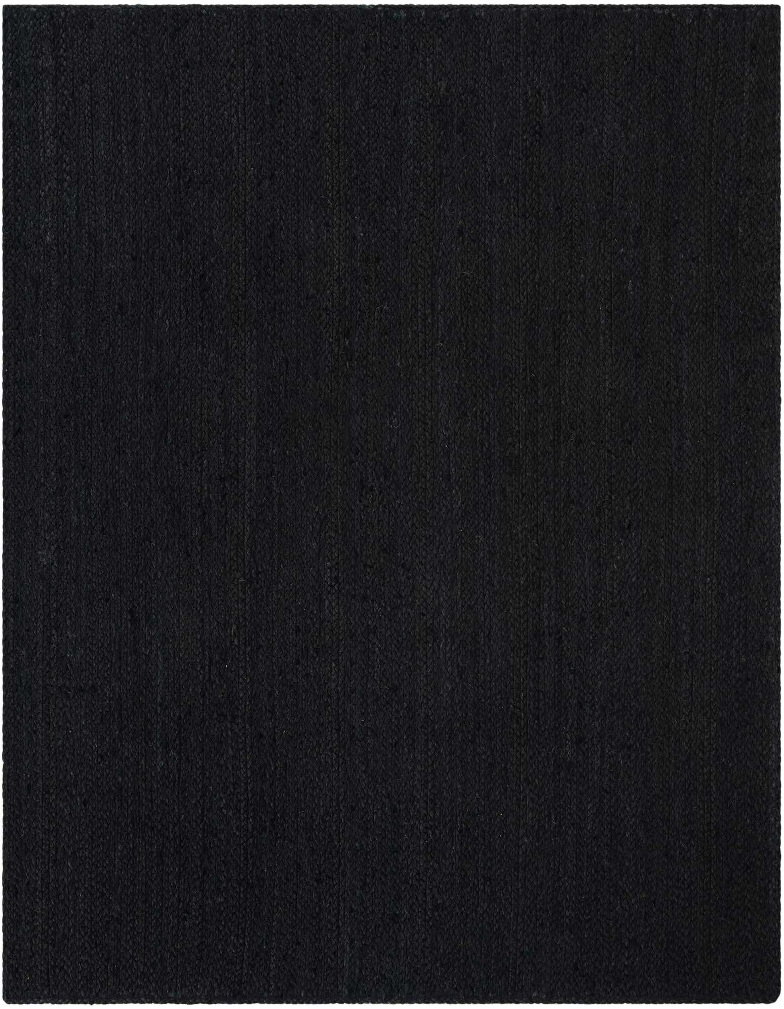 A close-up, overhead view of a black square jute rug with a textured, braided flatweave.