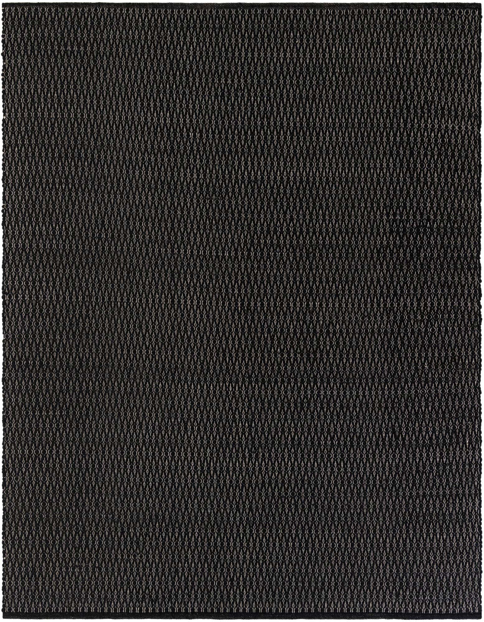 A close-up, overhead view of a black square rug with a subtle, textured lattice pattern, made from wool and cotton.