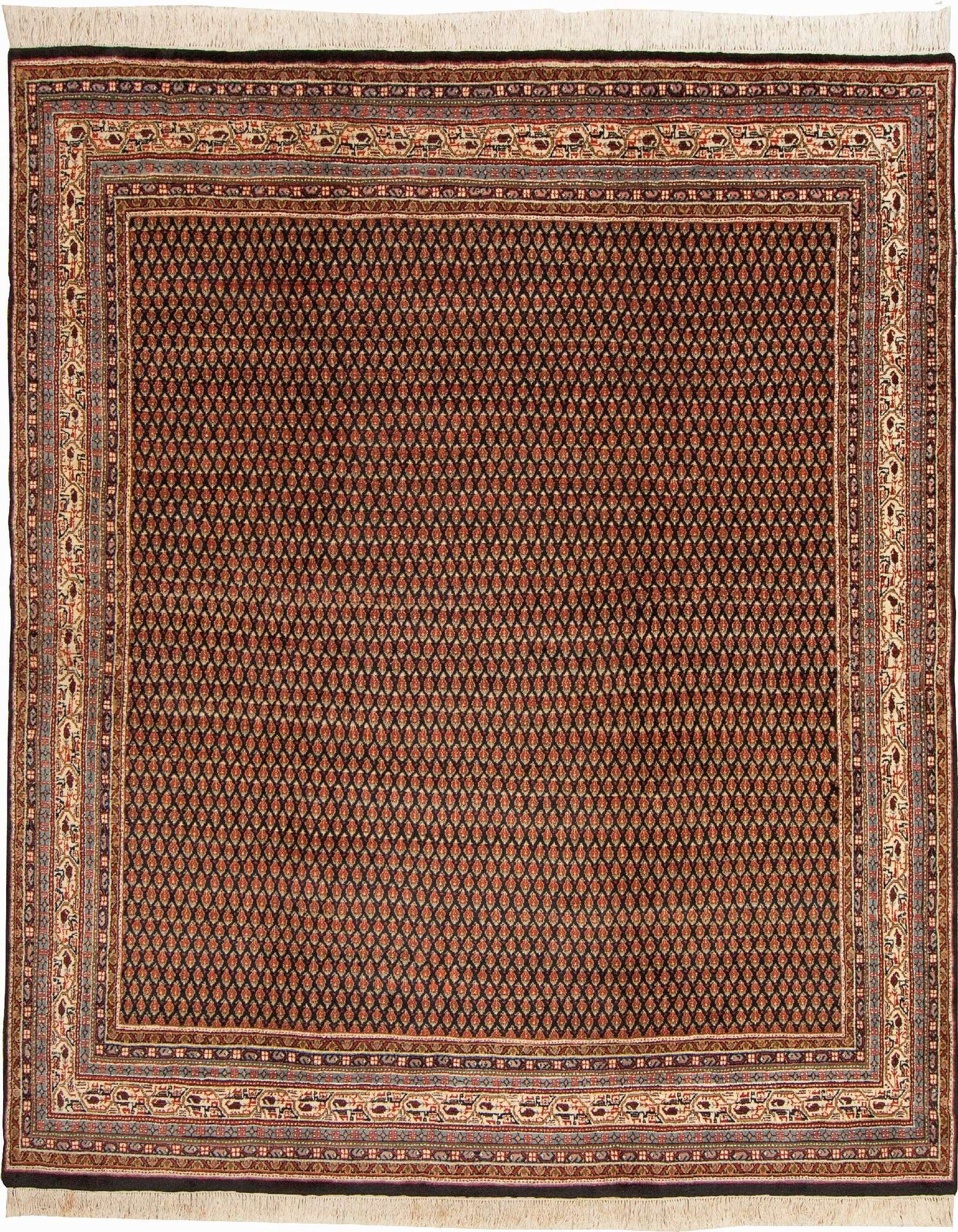A square black area rug with a repeating teardrop pattern in orange and red, framed by an intricate border in cream, blue, and brown.