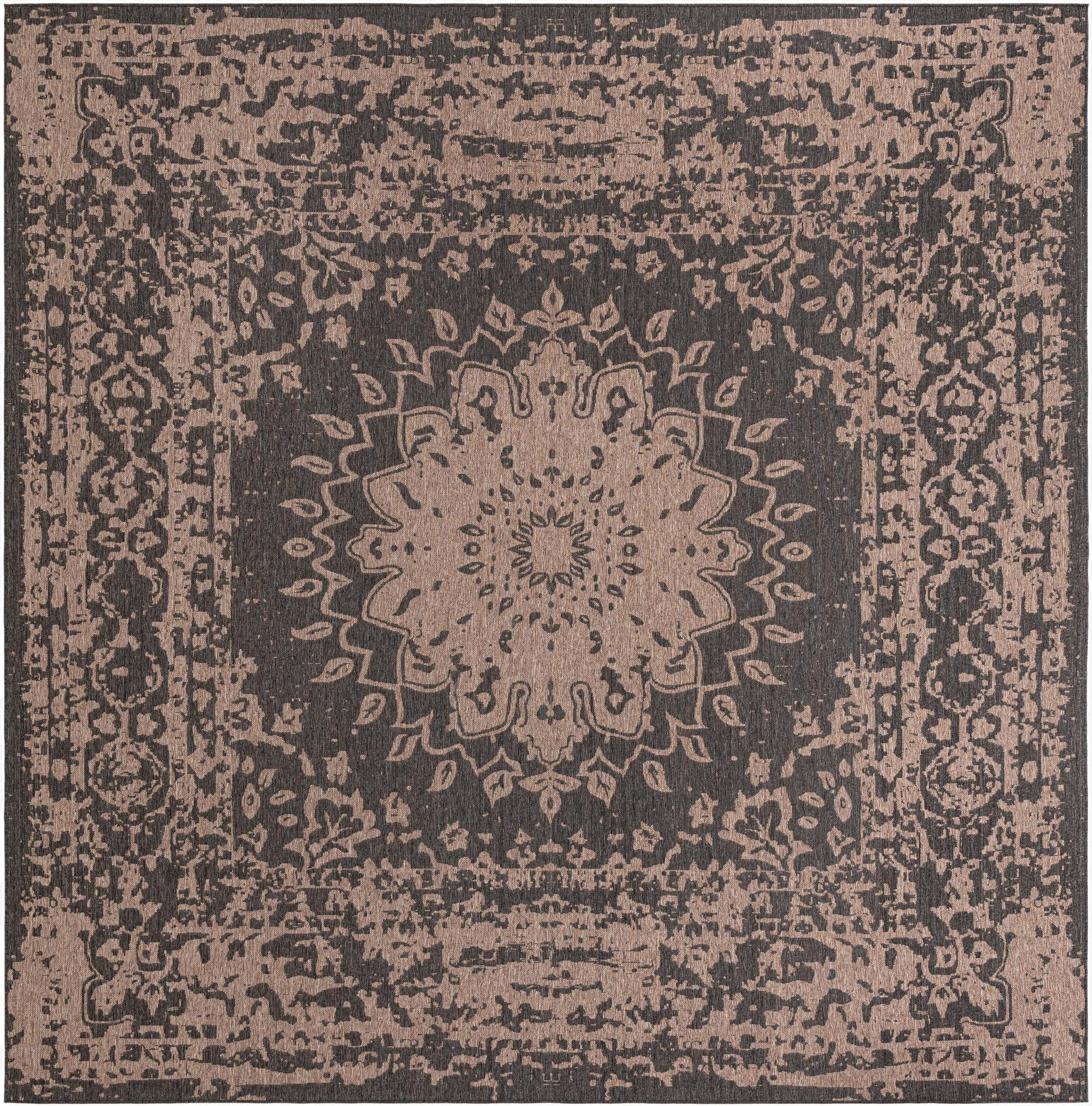 A 13' square black and beige modern outdoor rug with a large central medallion and distressed traditional patterns.