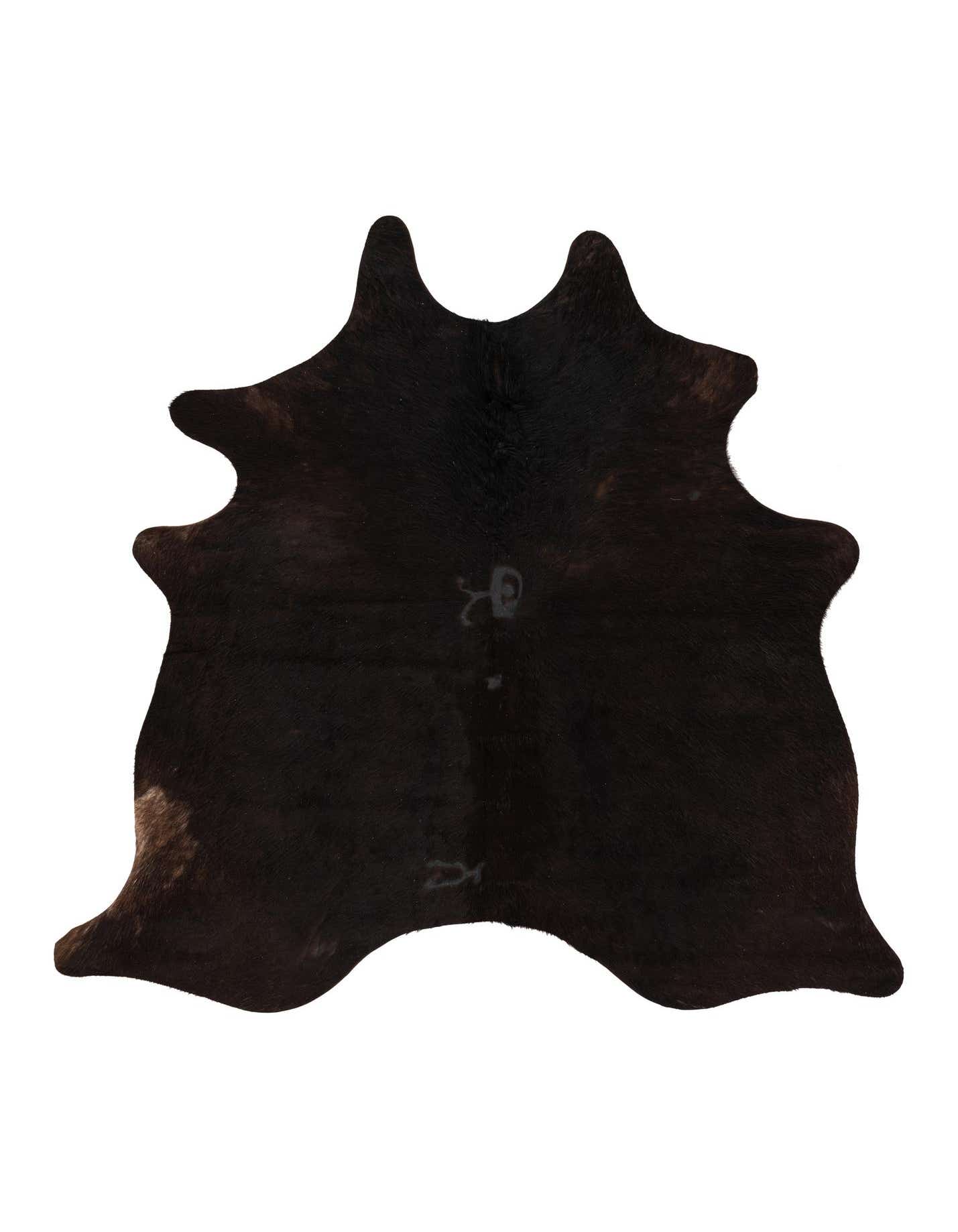 A 4' 5 x 5' 6 freeform black and brown cowhide rug with a natural, irregular shape, showcasing its textured, flat pile.
