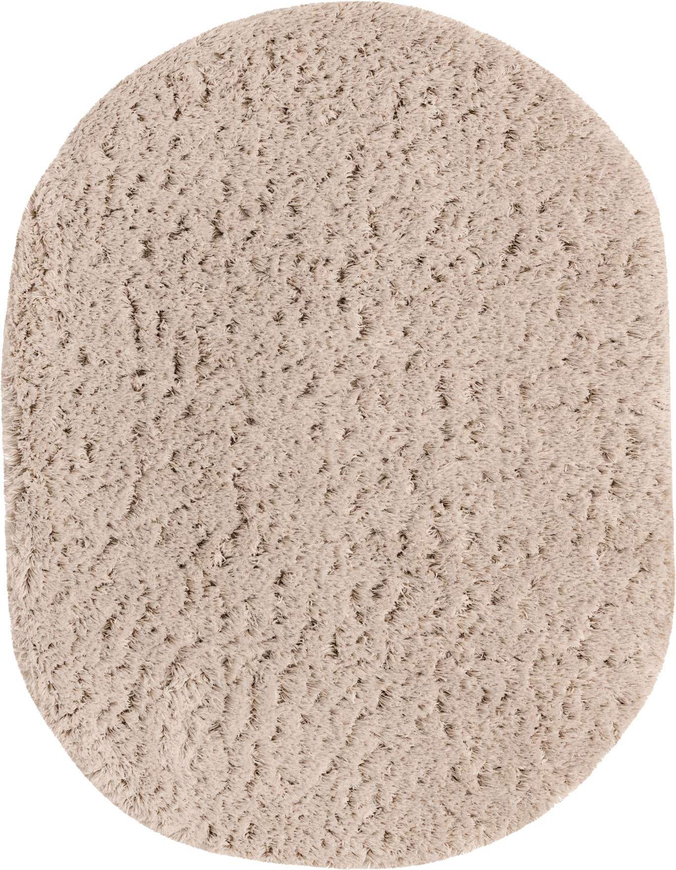 A plush, oval 5'3" x 8'0" shag rug in a warm ivory and tan blend, offering a soft, inviting texture.