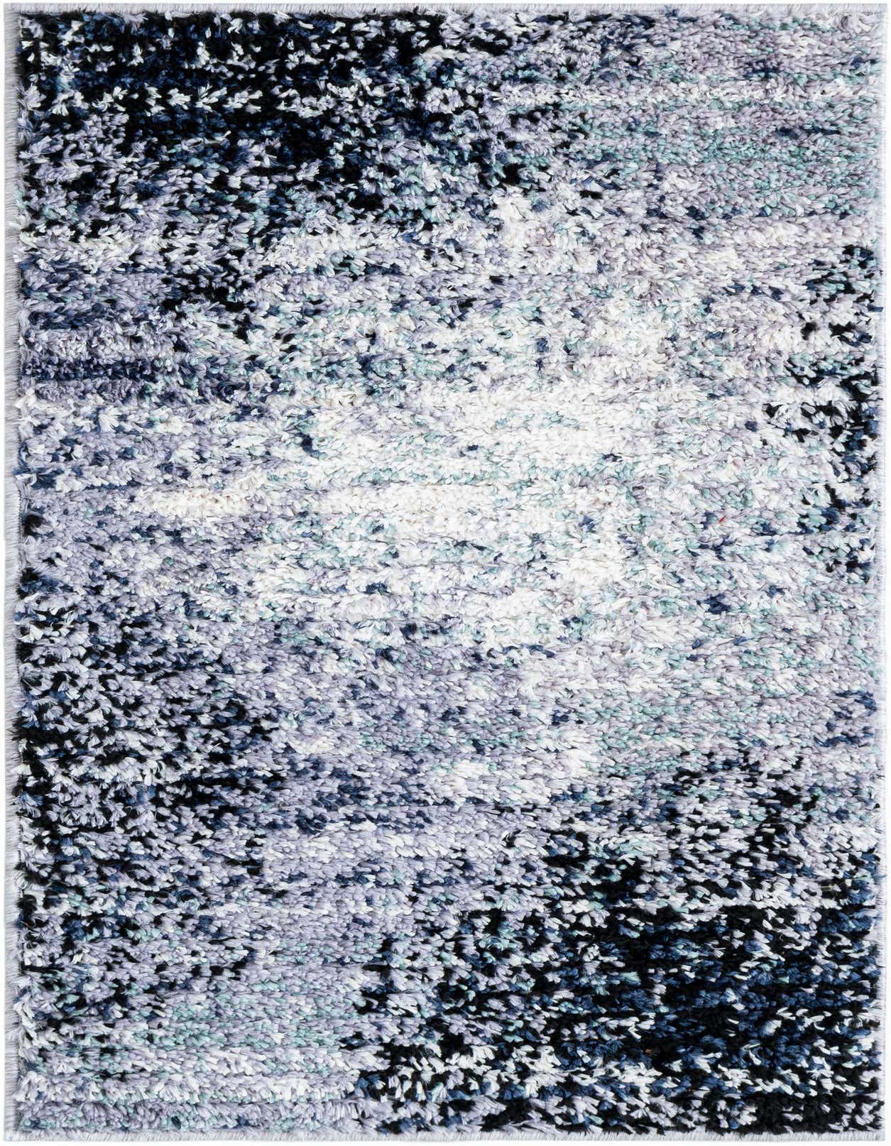 A rectangular 2x3 modern abstract shag rug in varying shades of blue, gray, and white, showcasing its textured pile.