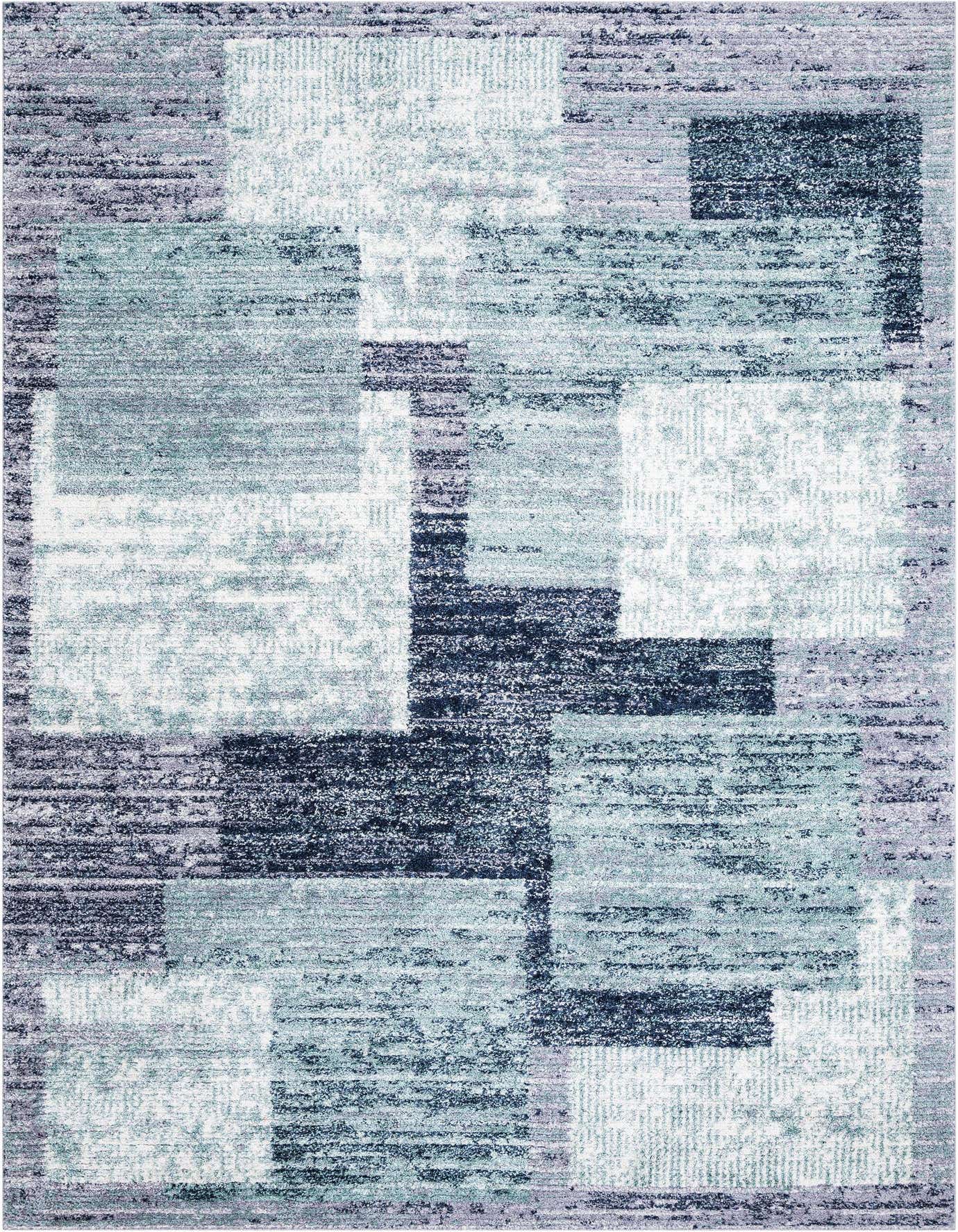 A 10x14 rectangular Rugs.com Tucson shag rug with an abstract pattern in varying shades of blue, gray, and silver.