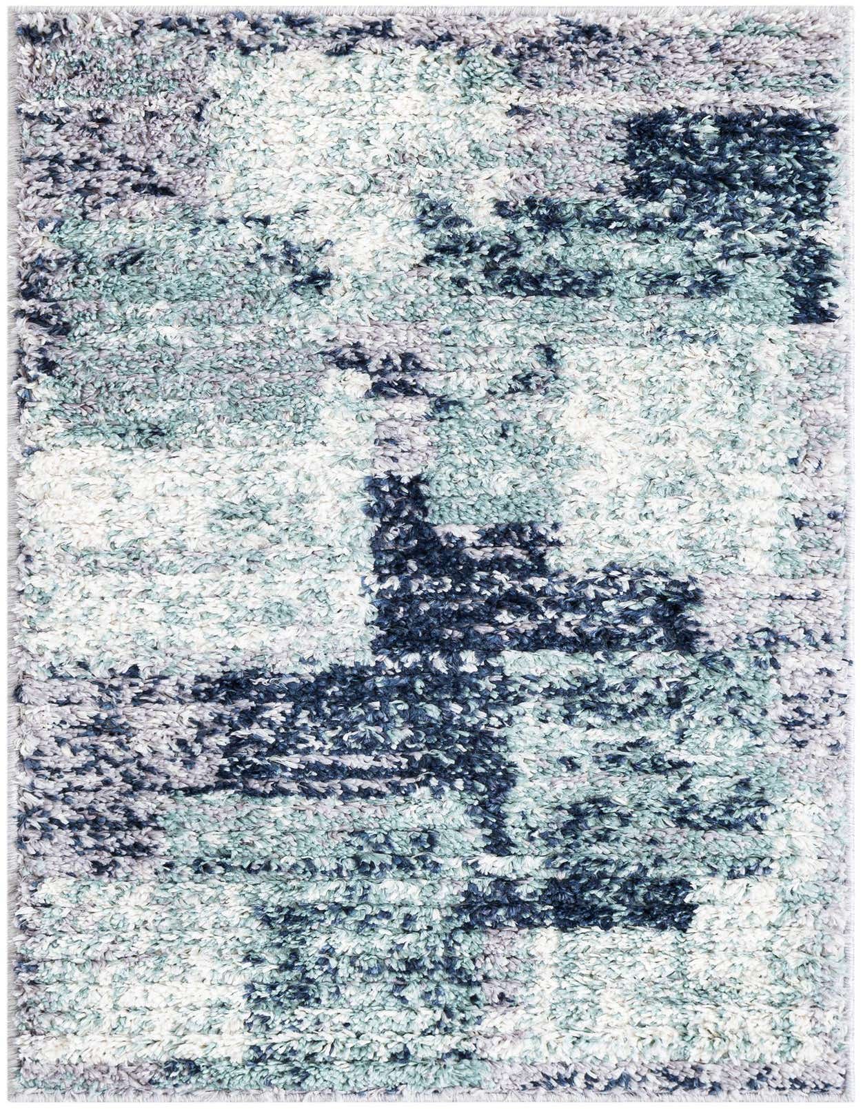 A rectangular 2x3 shag rug with an abstract pattern in varying shades of blue, gray, and white.
