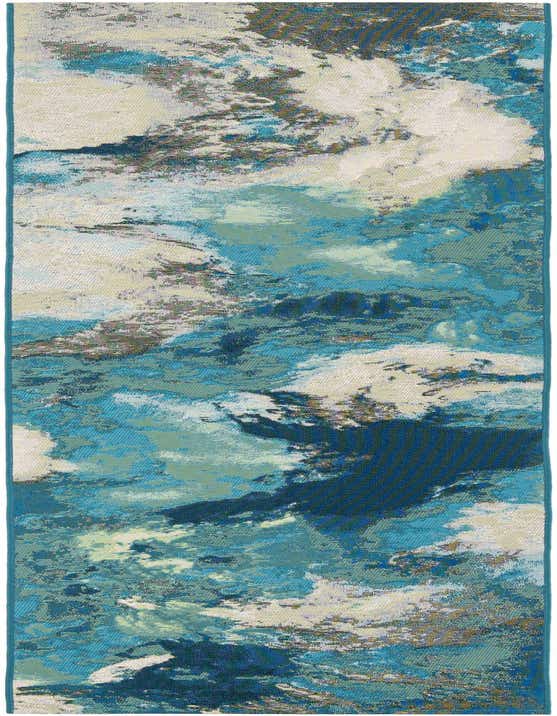 A 10 ft runner rug featuring an abstract, coastal-inspired pattern in various shades of blue and ivory, suitable for a hallway or patio.