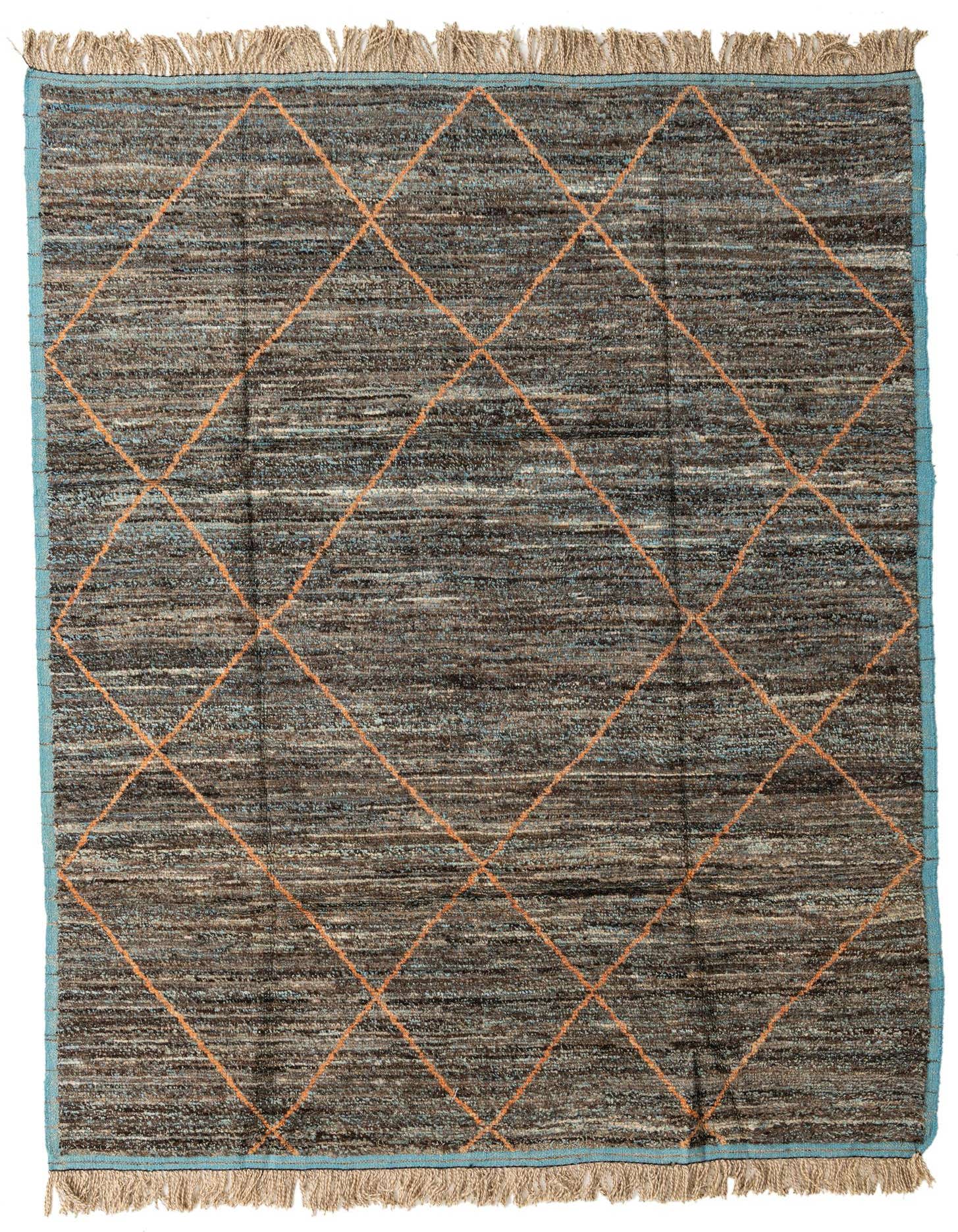 A rectangular 8x10 blue and brown shag rug with an orange tribal diamond pattern and fringed ends.
