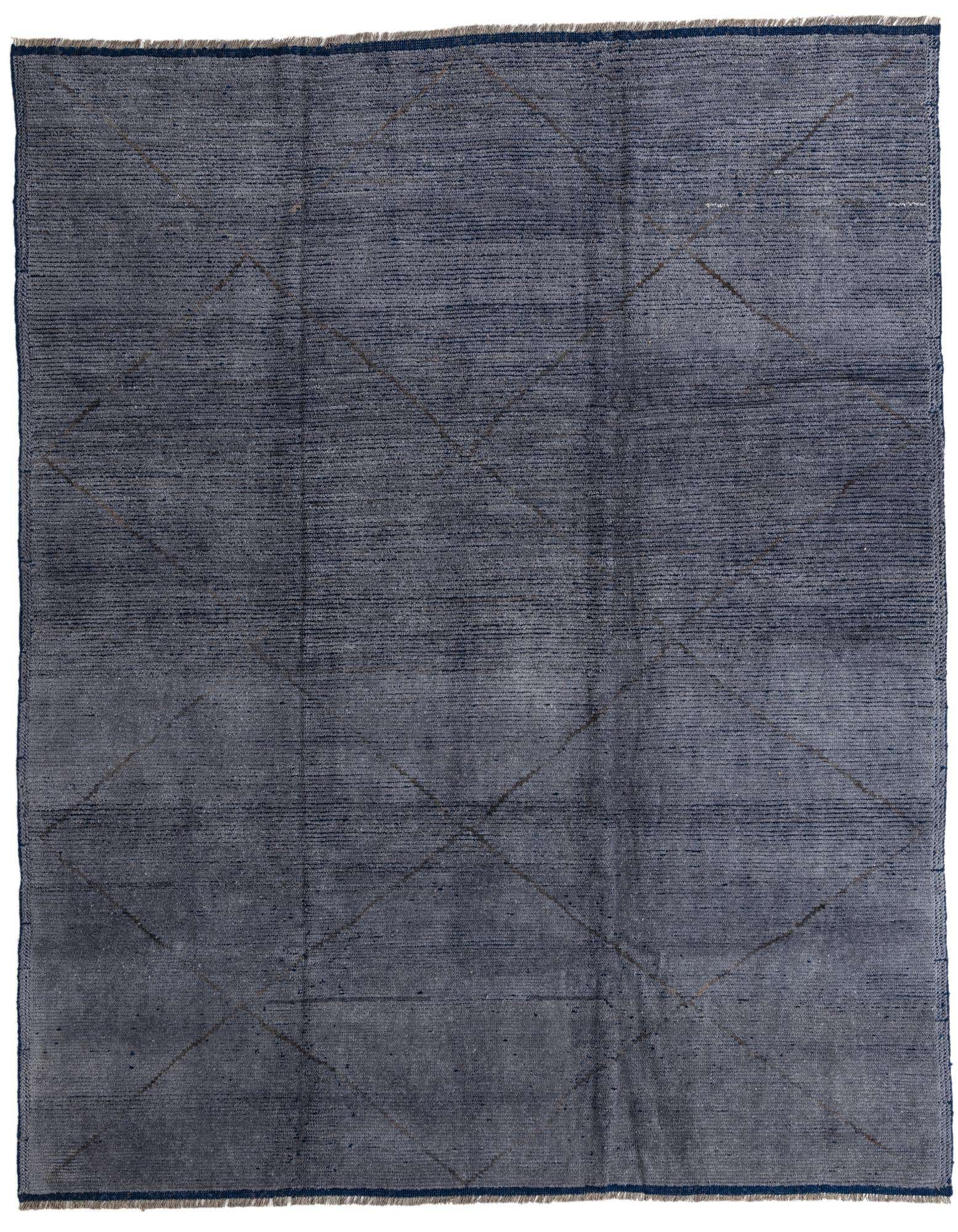 An 8x10 rectangular blue and gray wool shag rug with a subtle tribal geometric pattern, suitable for a living room.