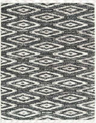 A 12 ft runner rug with a modern tribal trellis pattern in textured shades of blue and gray, featuring white tassels.