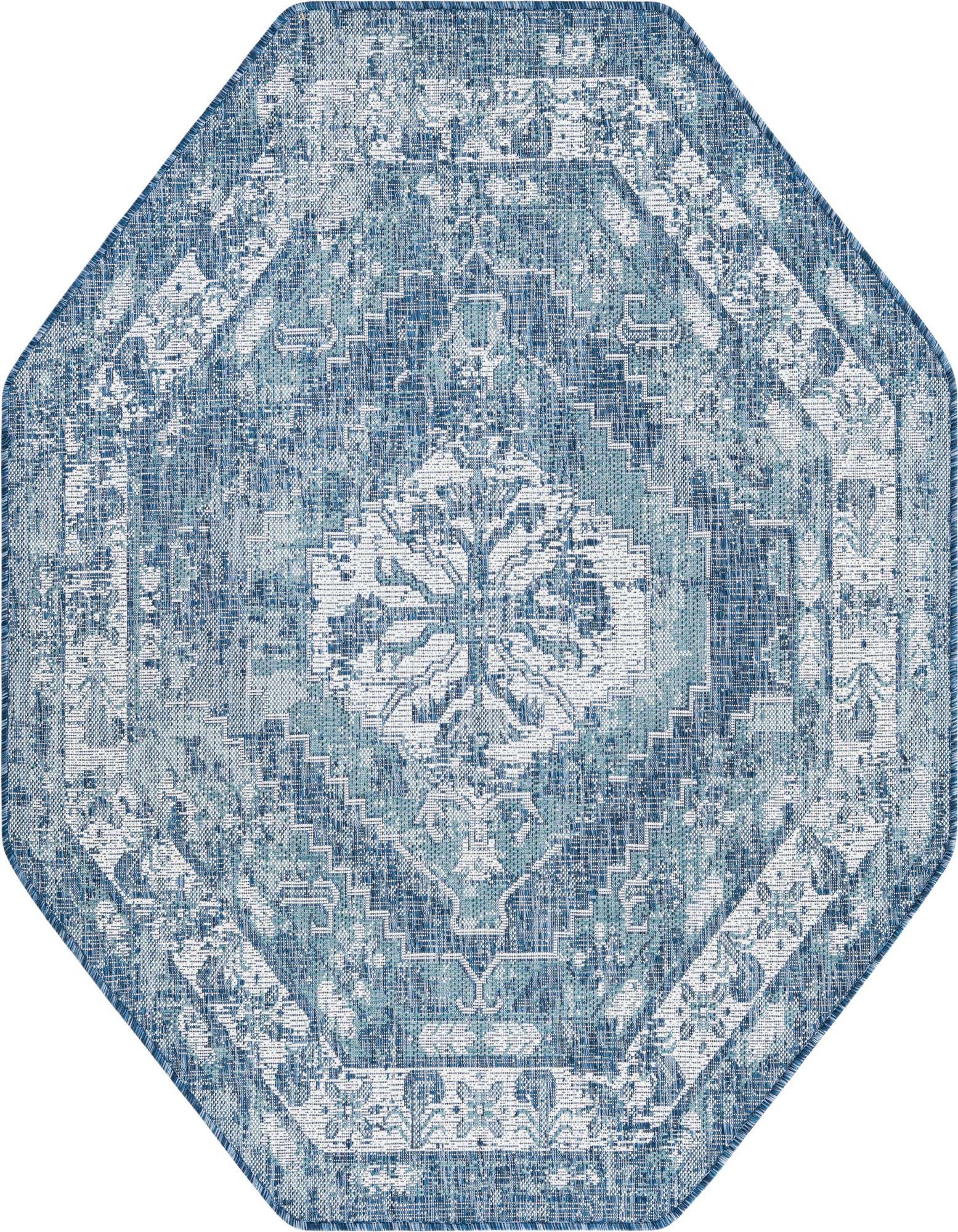 An octagon-shaped blue and white Southwestern-style outdoor rug with a distressed traditional pattern.