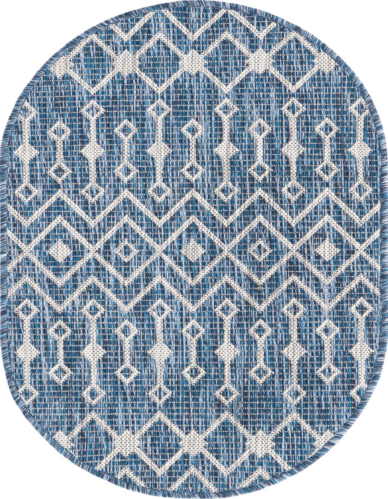 An oval blue and white tribal pattern flatweave rug, ideal for indoor or outdoor spaces like a patio.