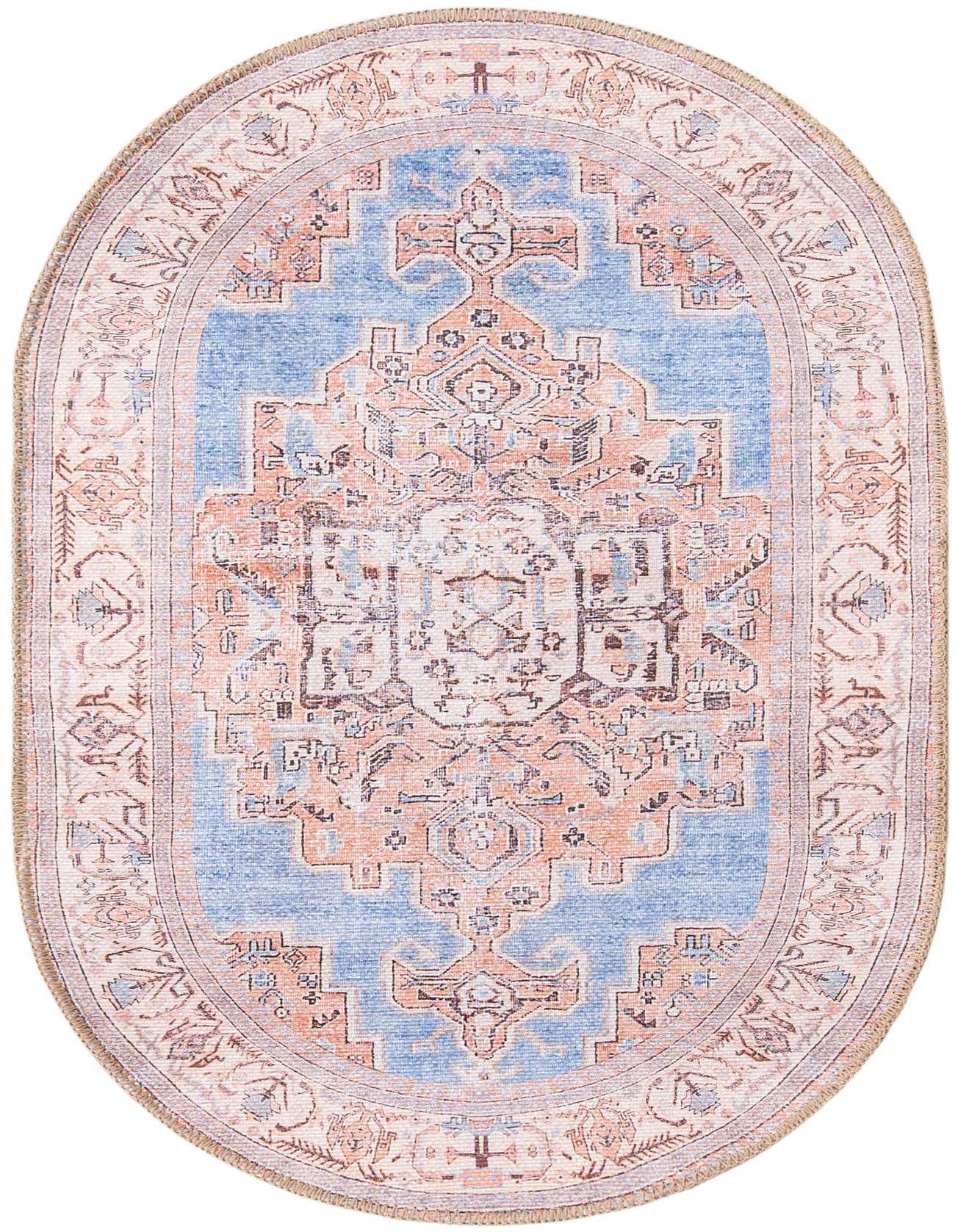 An oval blue and peach transitional rug with a vintage medallion pattern and a light border.