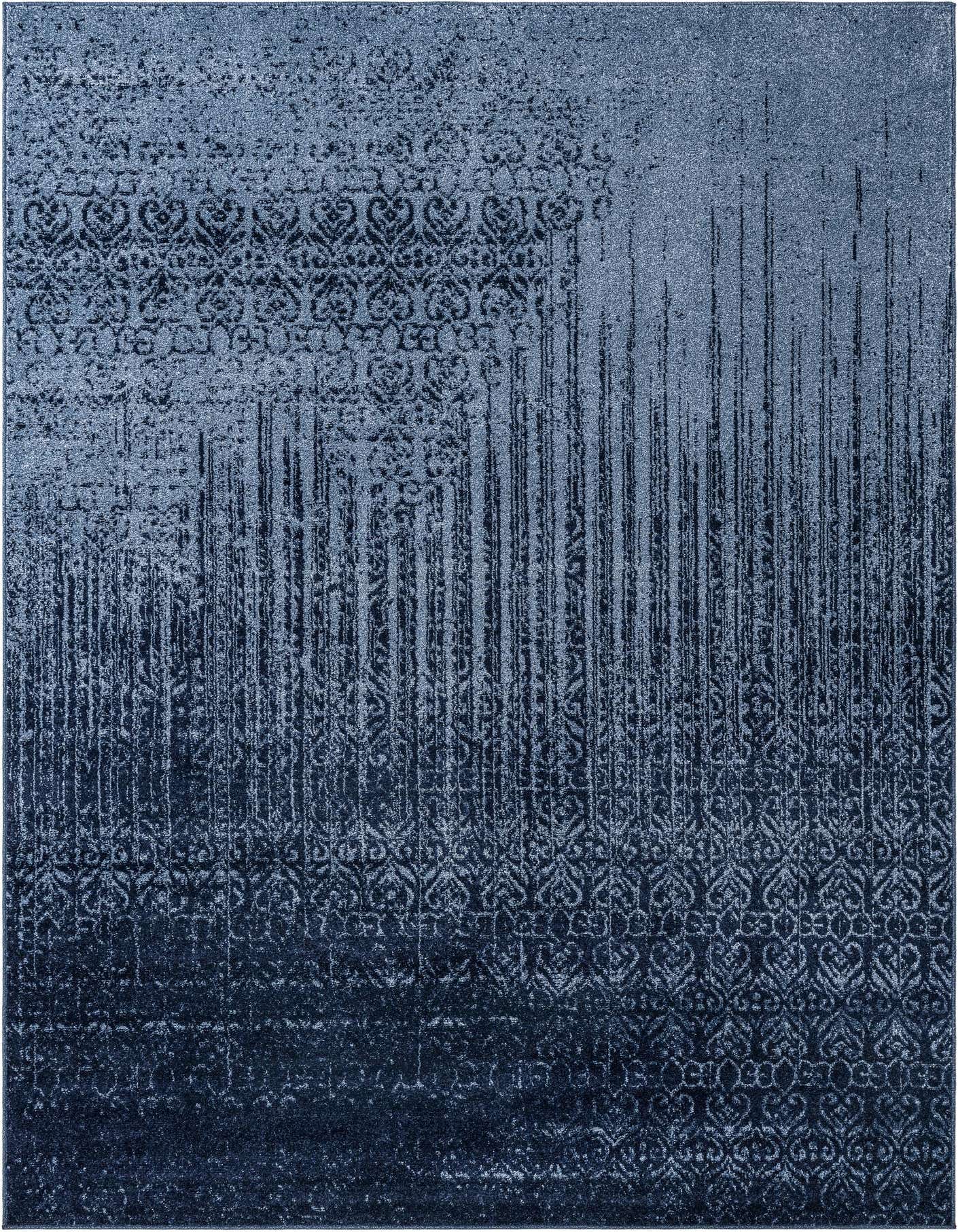 A 7x10 rectangular Angelica rug in varying shades of blue, featuring a transitional abstract pattern with faded damask motifs and vertical distressed lines.