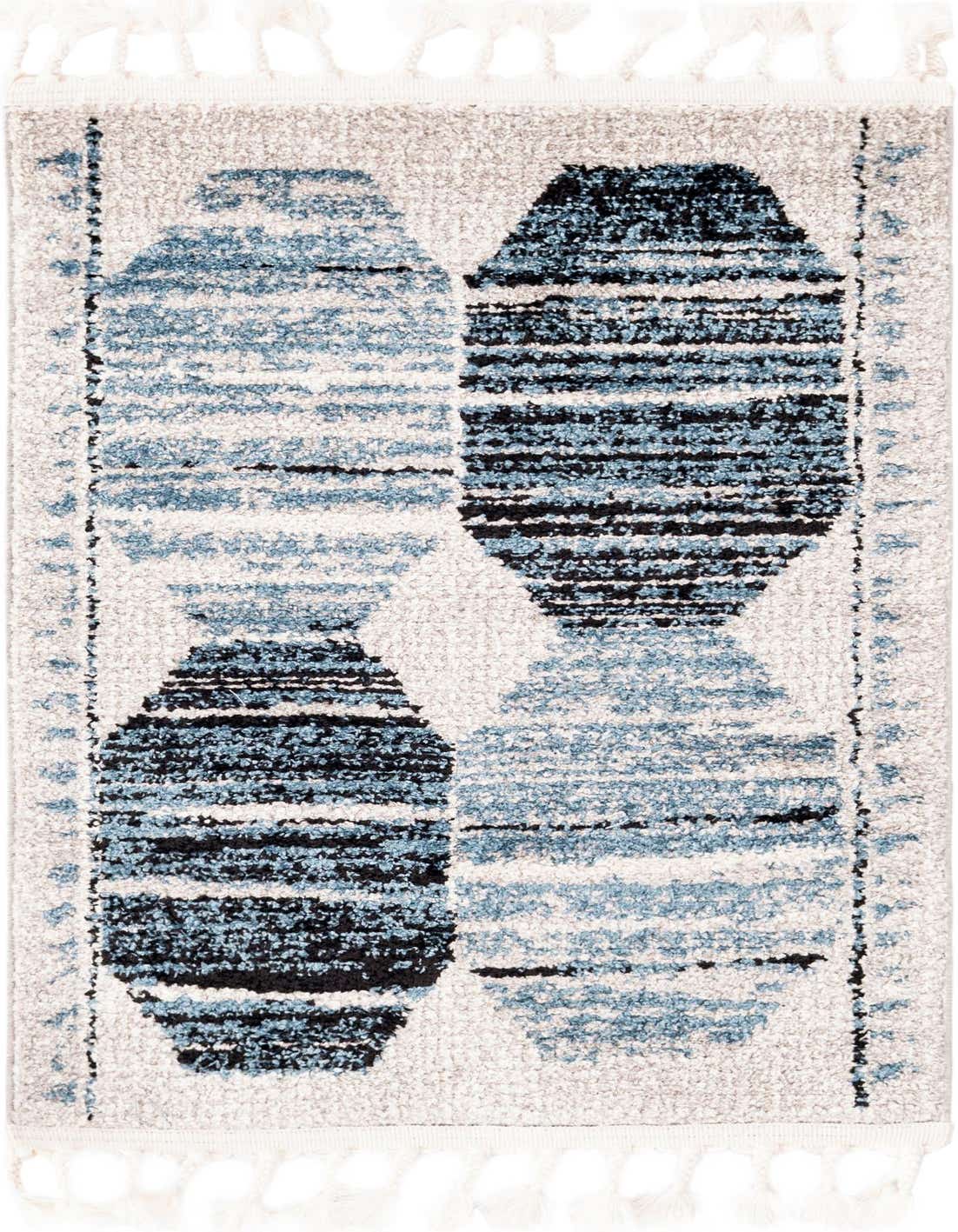 A 2x3 rectangular Aramis rug featuring a modern stripe pattern in varying shades of blue and black on a light grey background, with decorative tassels.