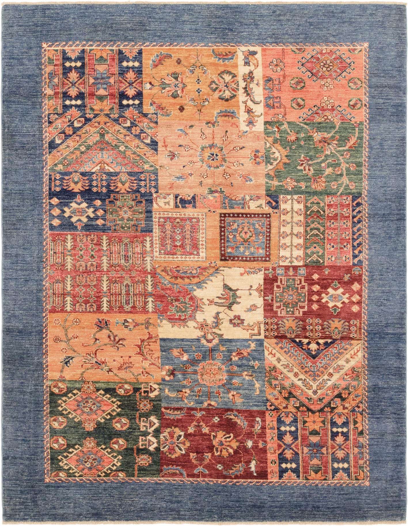 A 6x9 rectangular Ariana Ziegler rug featuring a Southwestern patchwork design in various shades of blue, orange, red, and green, framed by a solid blue border.