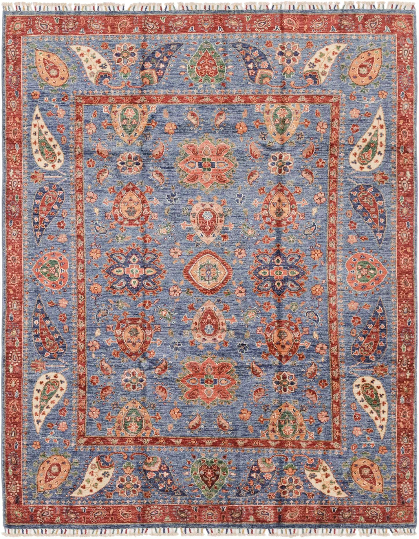 A 6x9 rectangular Ariana Ziegler rug featuring a traditional tribal pattern in various shades of blue and red, with intricate floral and paisley motifs.
