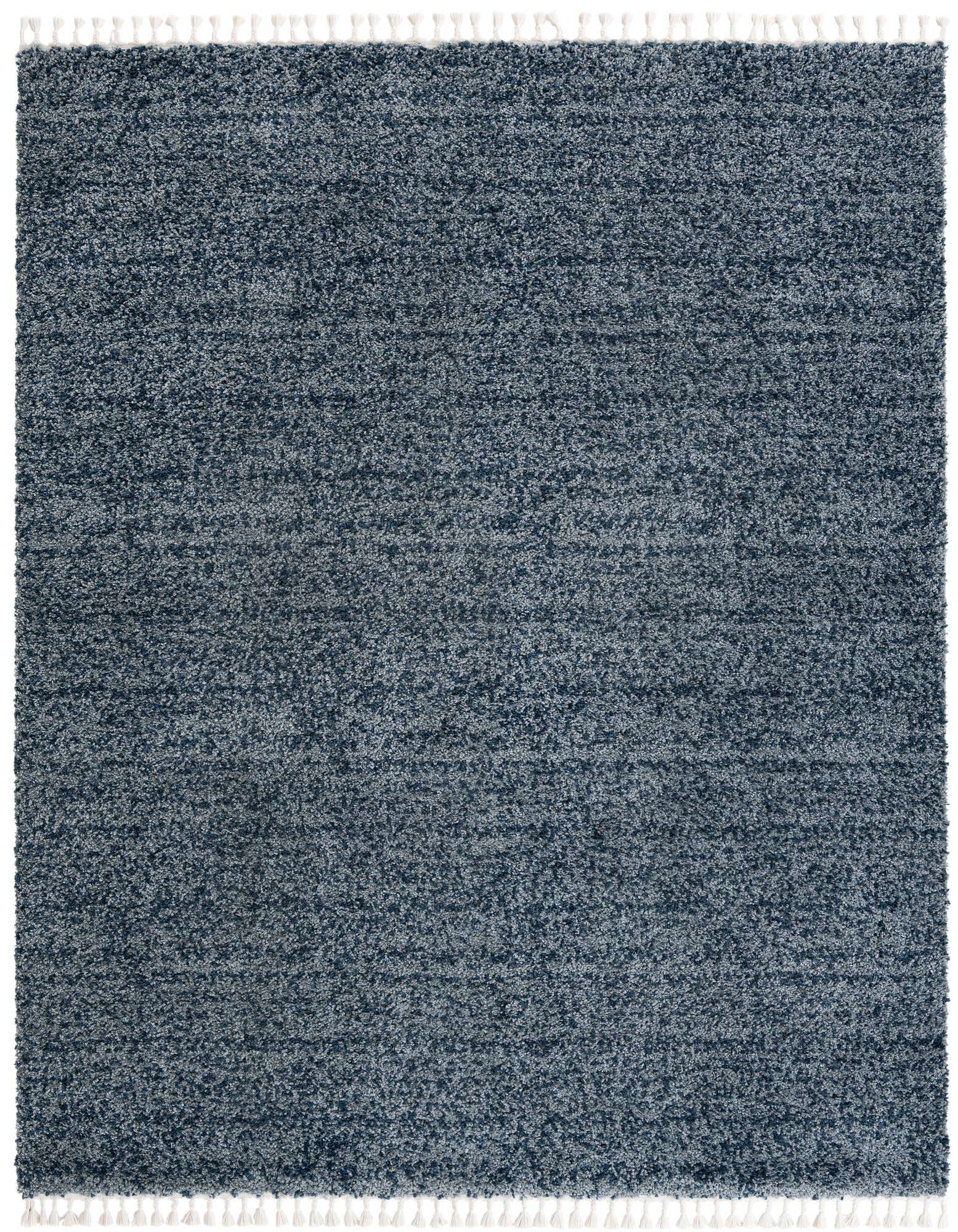 A rectangular 8x10 Athena Shag rug in varying shades of blue, featuring a plush pile and white tassels.