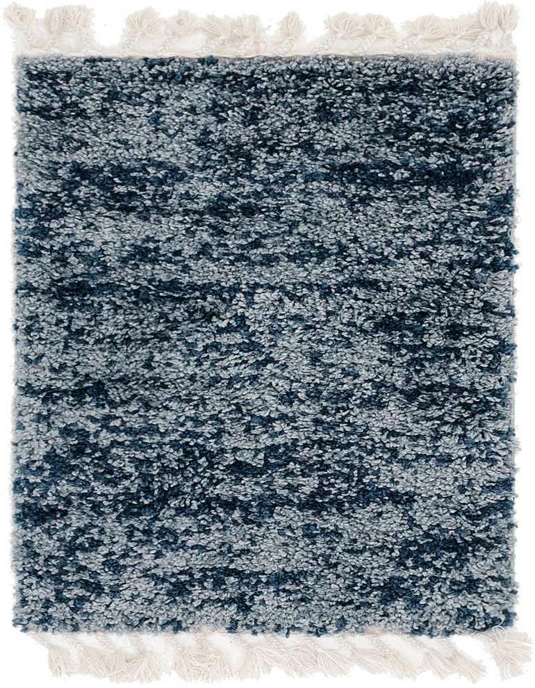A 2x3 rectangular Athena Shag rug in varying shades of blue, featuring a plush pile and decorative white tassels.
