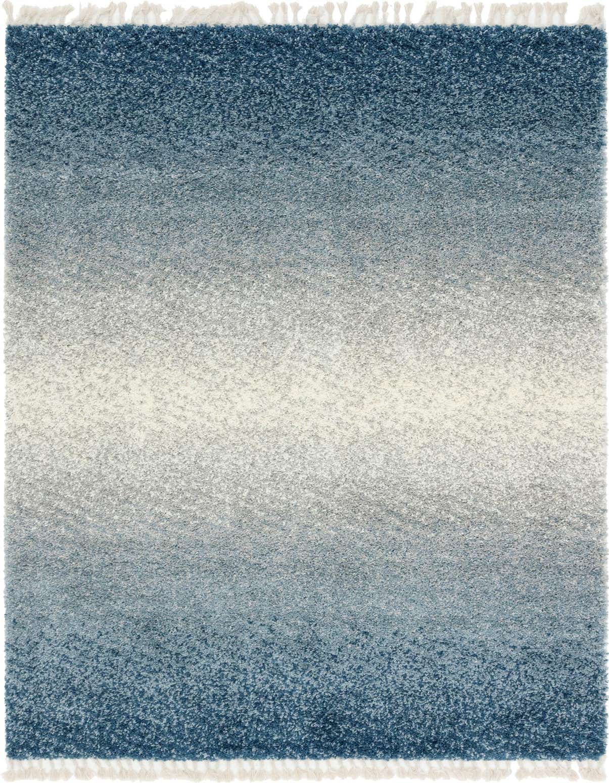 A 5x8 rectangular Athena Shag rug featuring a blue to white ombre design with white tassels on the ends.