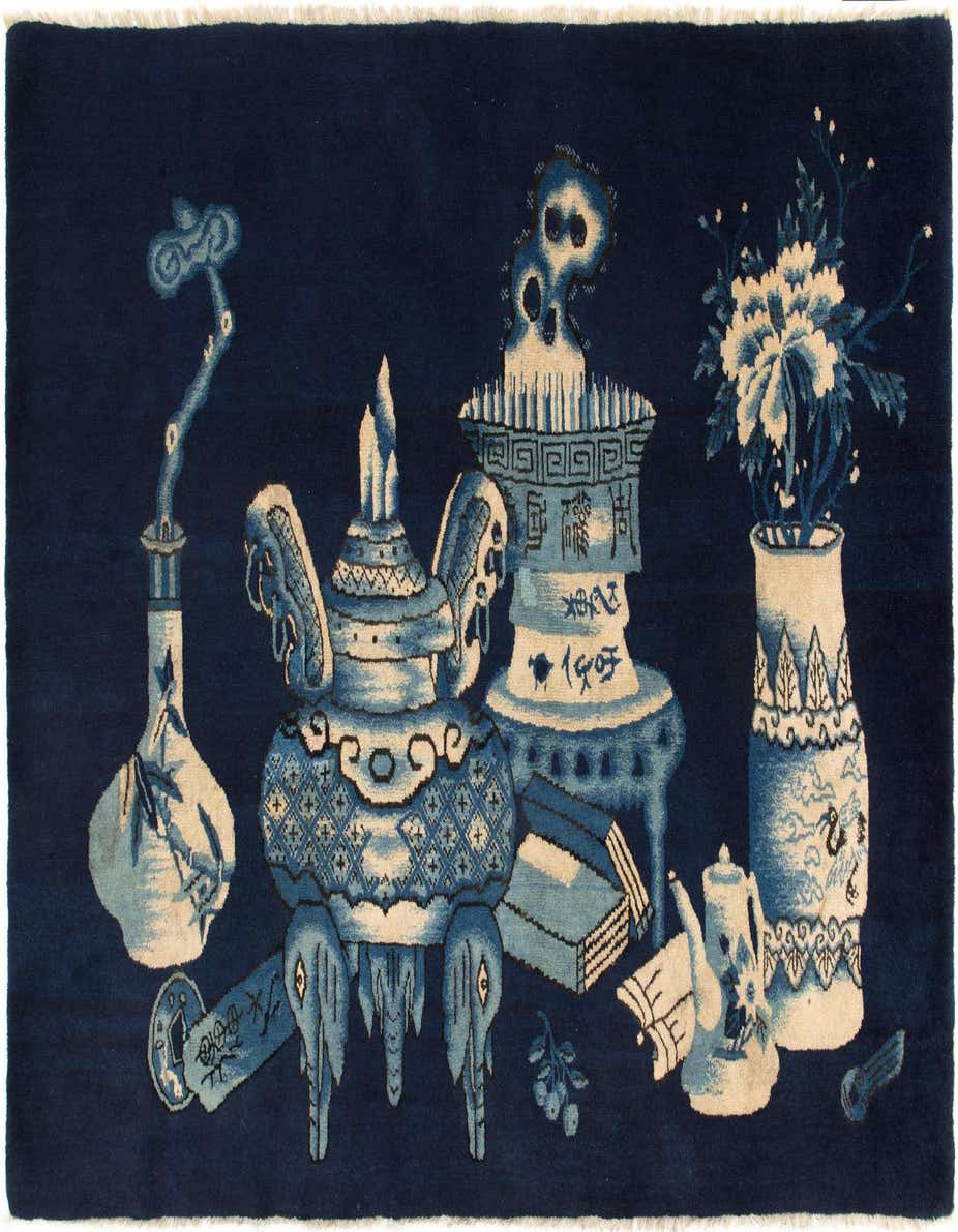 A 3x5 rectangular blue wool rug with a traditional Chinese motif featuring vases, an incense burner, and other decorative objects in lighter blue and cream.