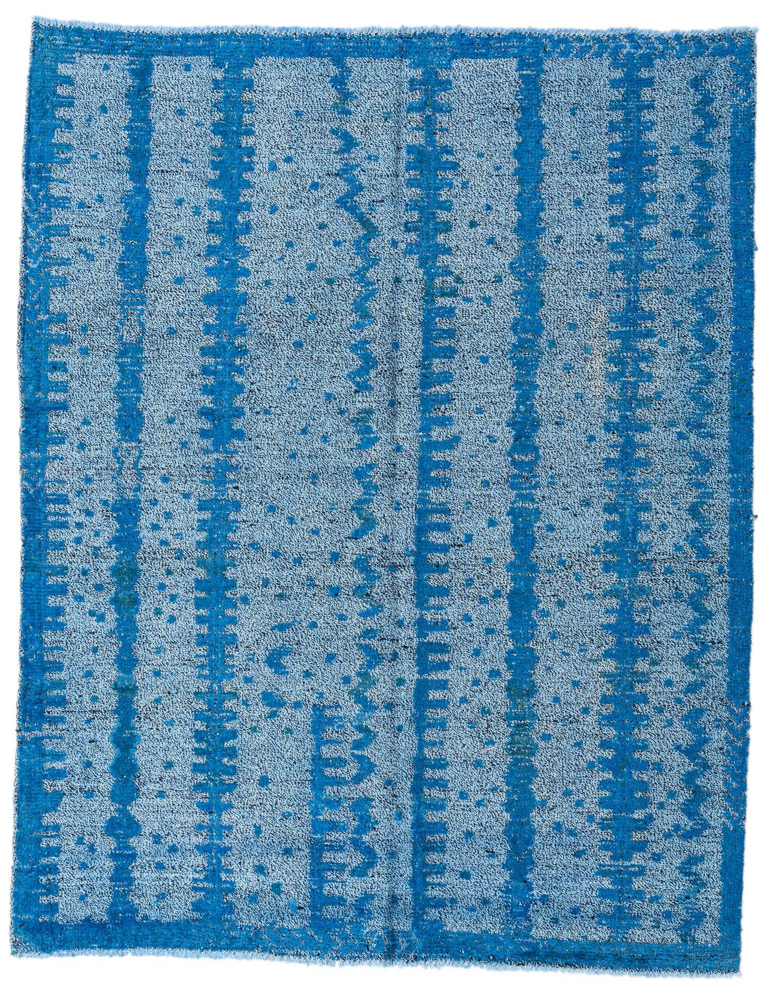 A 5x8 rectangular Darya Collection rug featuring a modern abstract pattern in varying shades of blue, handmade with a textured wool pile.