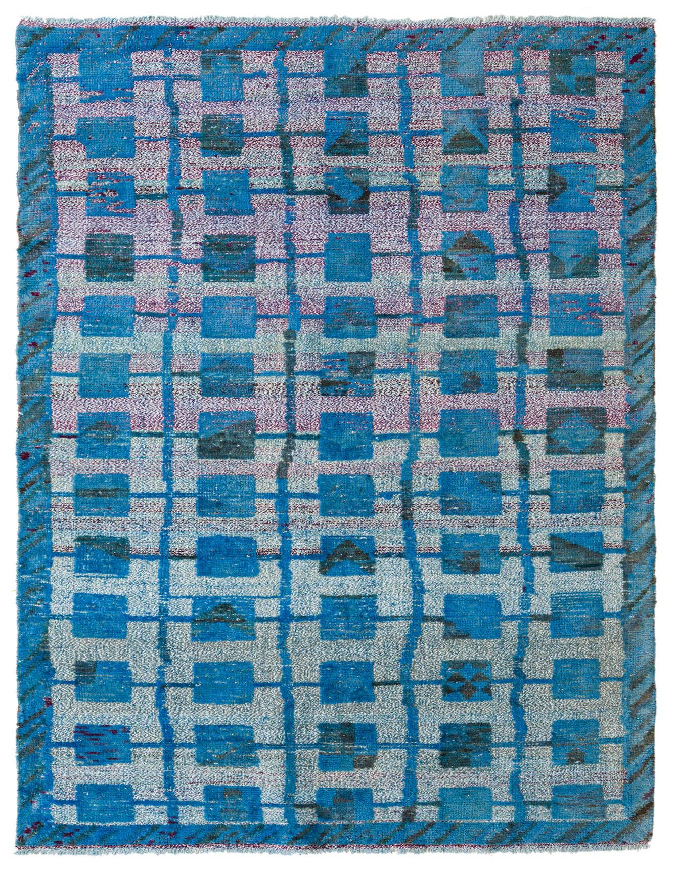 A 5x8 rectangular Darya rug with a modern grid pattern in various shades of blue and hints of light pink, handmade from wool.