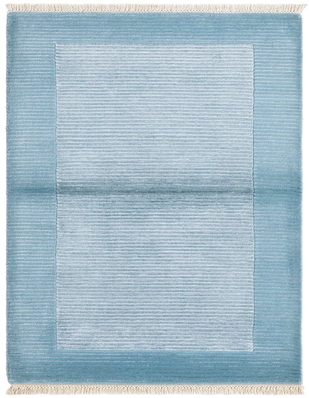 A 3x5 rectangular Darya rug in varying shades of blue, featuring a modern striped pattern and cream fringes.