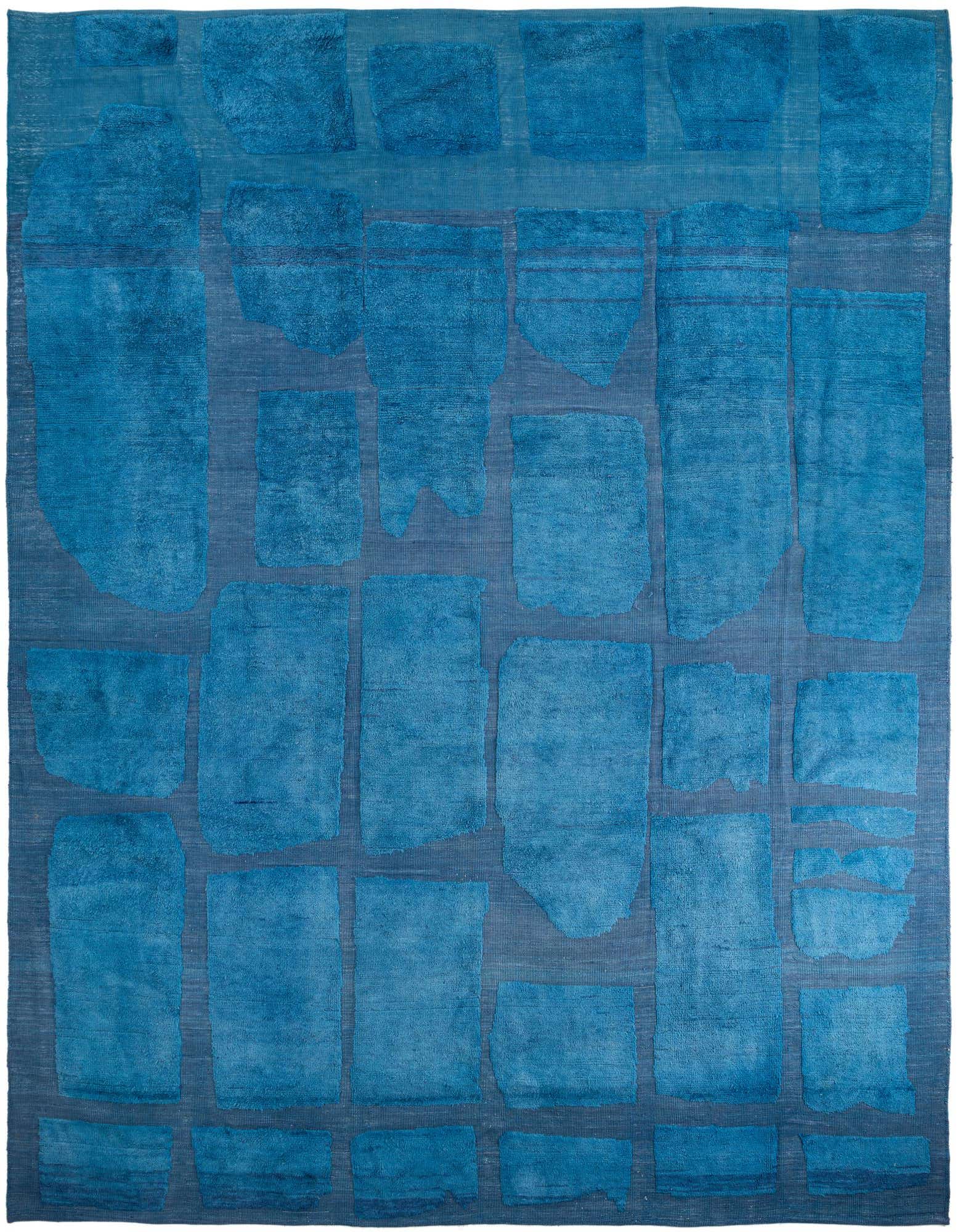 A large 12x15 rectangular blue wool rug with an abstract modern pattern of varying textured blue shapes on a lighter blue background.