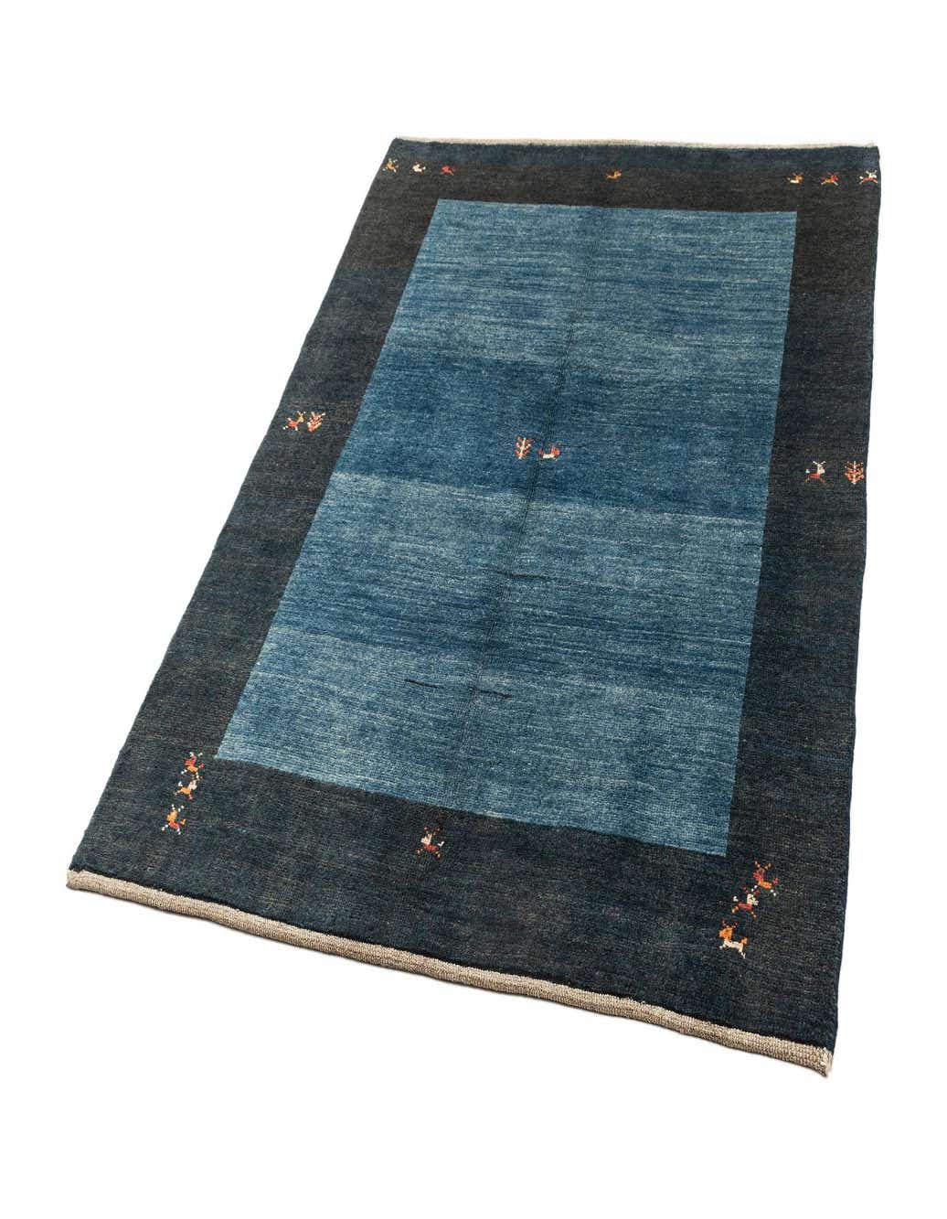 A 4x6 rectangular Gabbeh Shouli rug featuring a blue center and a dark blue border with small, colorful abstract patterns.