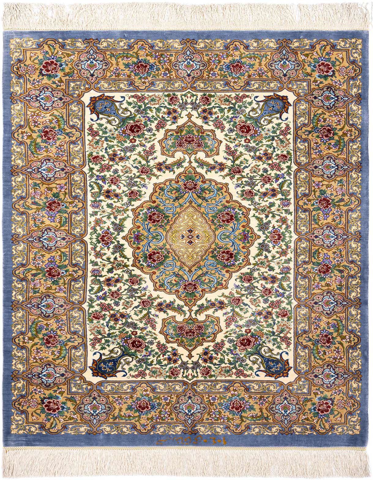 A 3x4 rectangular Ghom Silk Persian rug featuring a central medallion and intricate floral patterns in blues, reds, and golds on a cream background, with a blue border and white fringe.