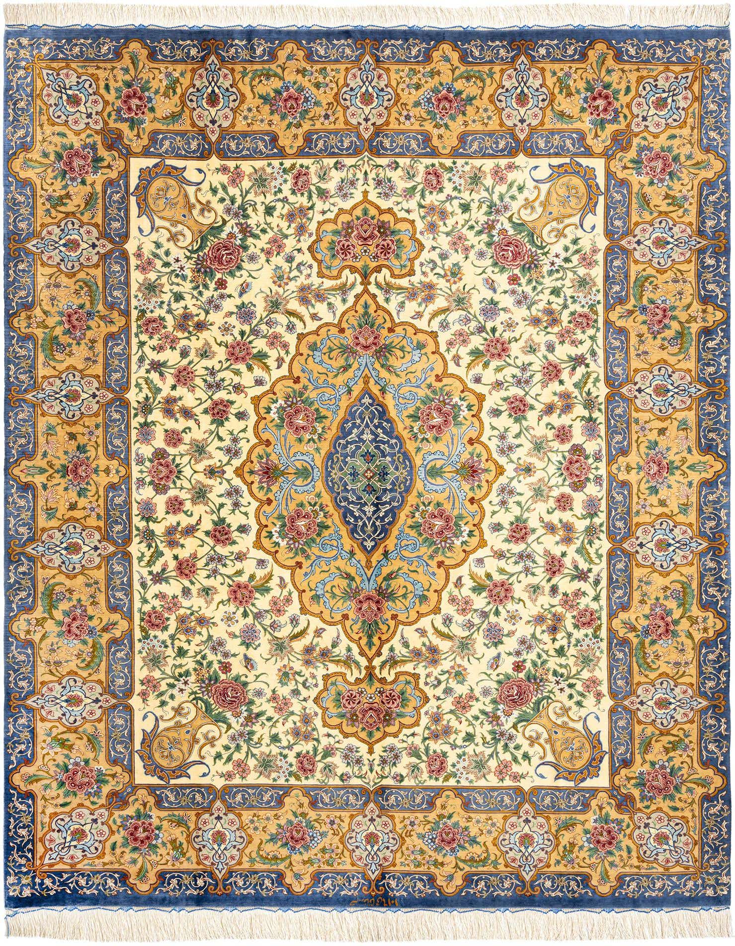 A 6x9 rectangular Ghom Silk Persian rug featuring a central blue medallion and intricate floral patterns in blue, gold, and red on a cream background, with a blue border.