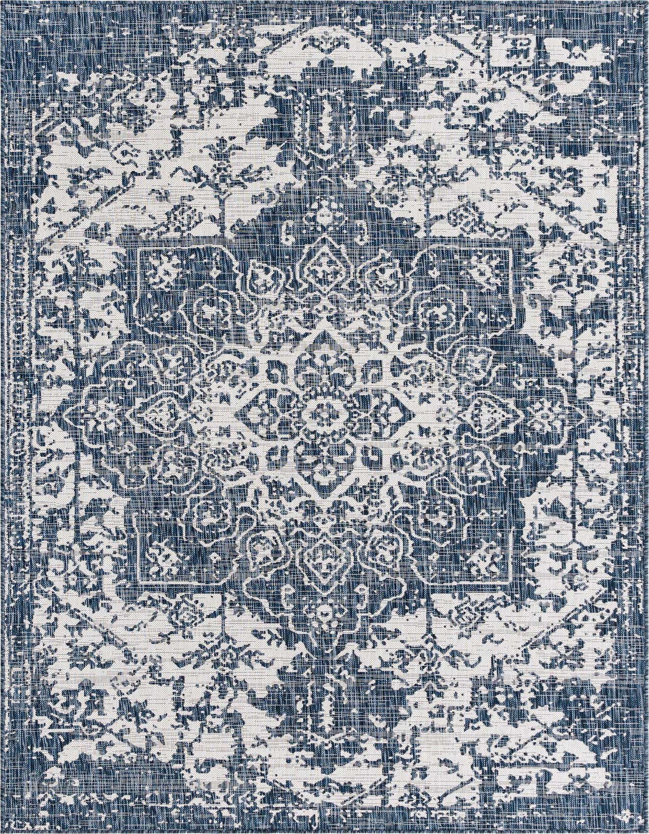 A 6x9 rectangular Jill Zarin Outdoor rug featuring a distressed blue and white Mediterranean medallion pattern, ideal for a living room or patio.