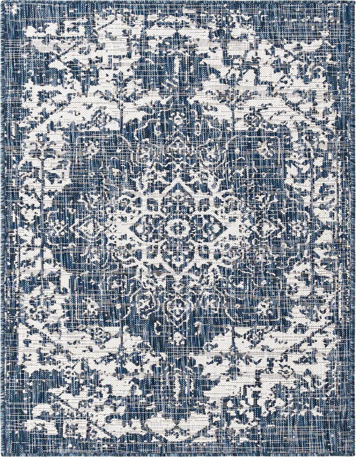 A 3x5 rectangular Jill Zarin Outdoor rug featuring a distressed blue and white Mediterranean medallion pattern, ideal for a patio.