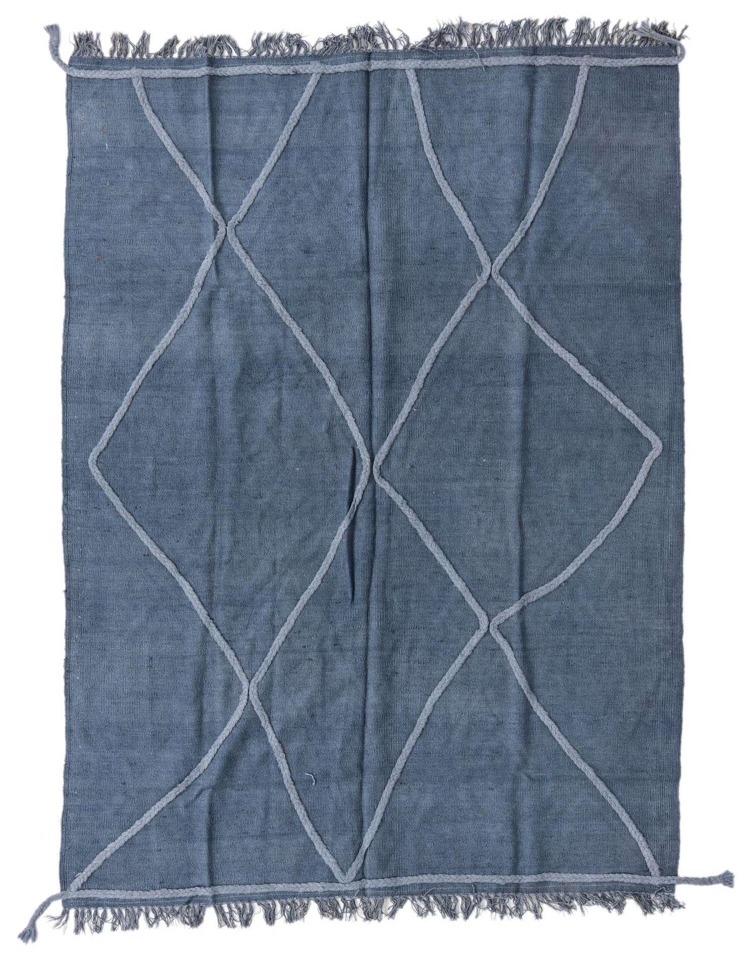 A 4x6 rectangular blue flatweave wool rug with a light grey tribal diamond pattern and fringed edges.