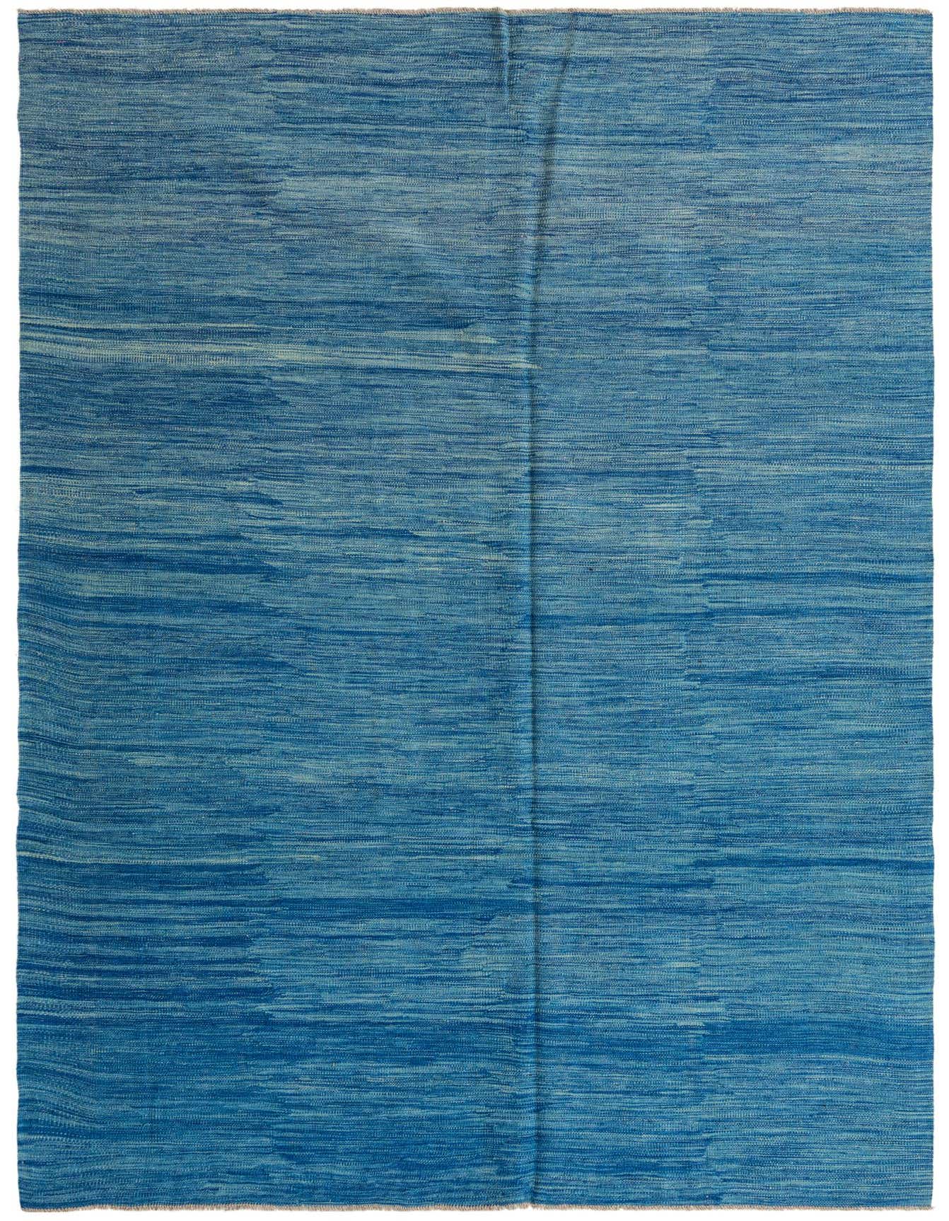 A 7x10 rectangular flatweave rug with varying shades of blue, showcasing a modern tribal pattern.