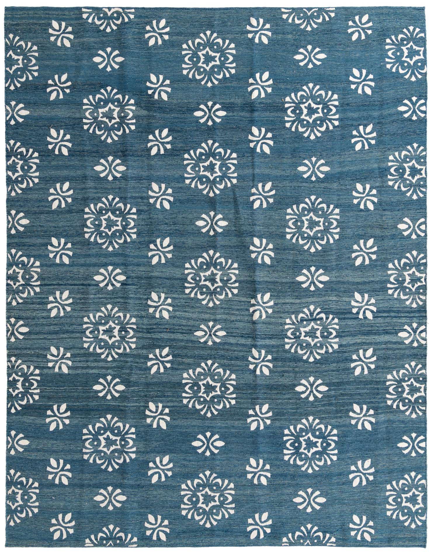 A rectangular 8x11 blue flatweave rug with a scattered white tribal medallion and abstract floral pattern, suitable for a living room.