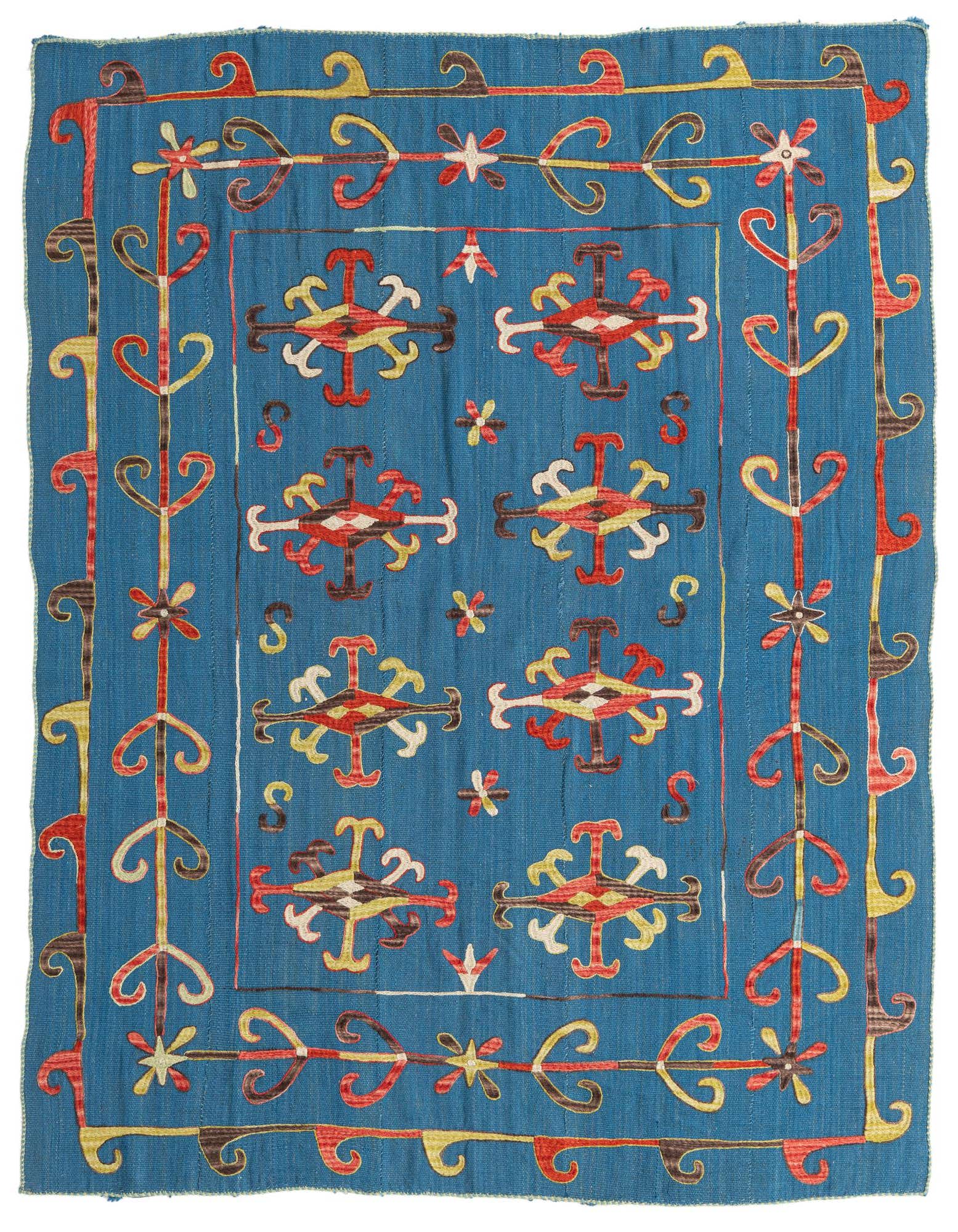 A 5x8 rectangular blue Kilim Suzani rug with a tribal, modern, and oriental pattern in red, yellow, and brown.
