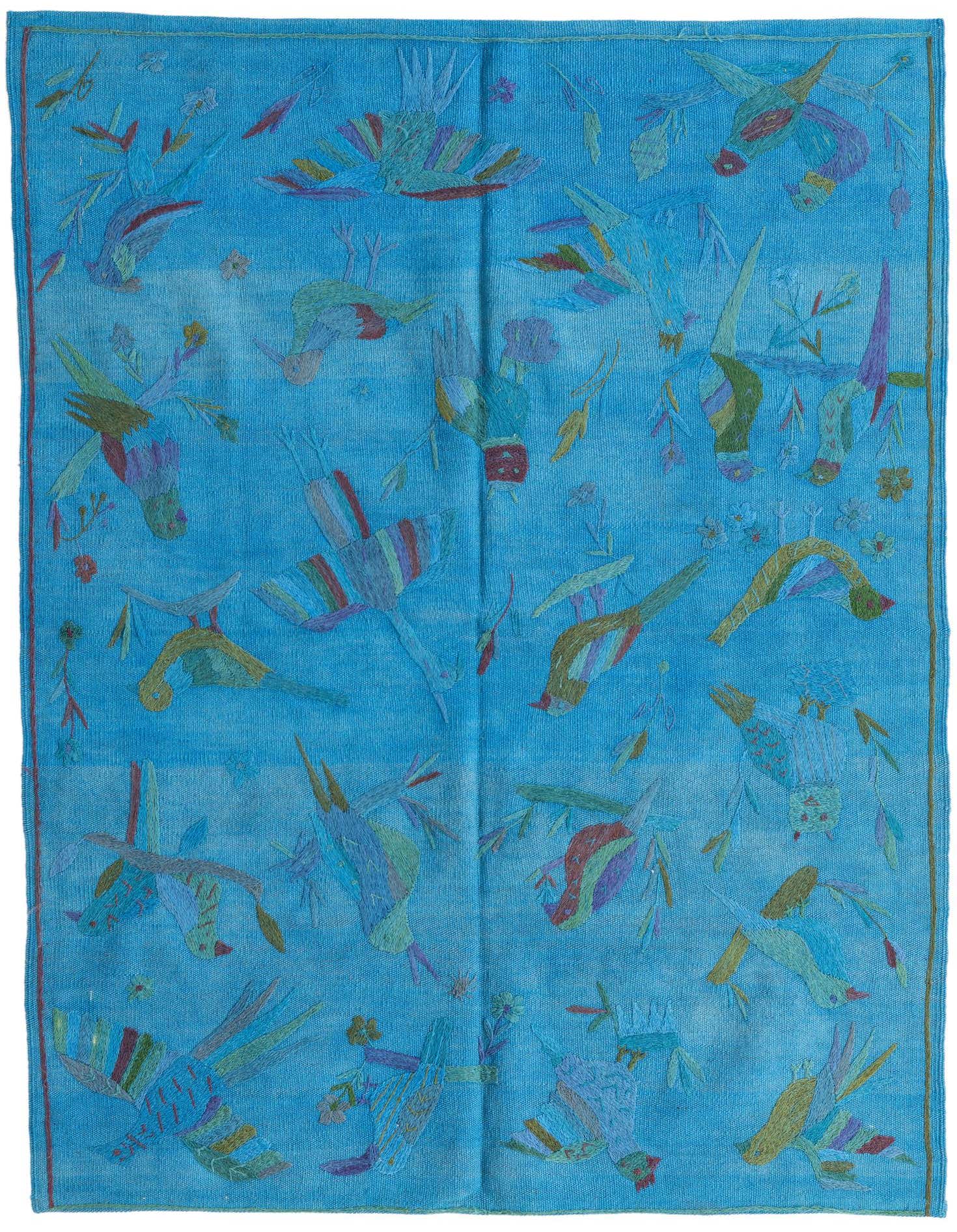 A 4x6 rectangular blue wool Kilim Suzani rug featuring colorful tribal bird and floral patterns, ideal for a living room.