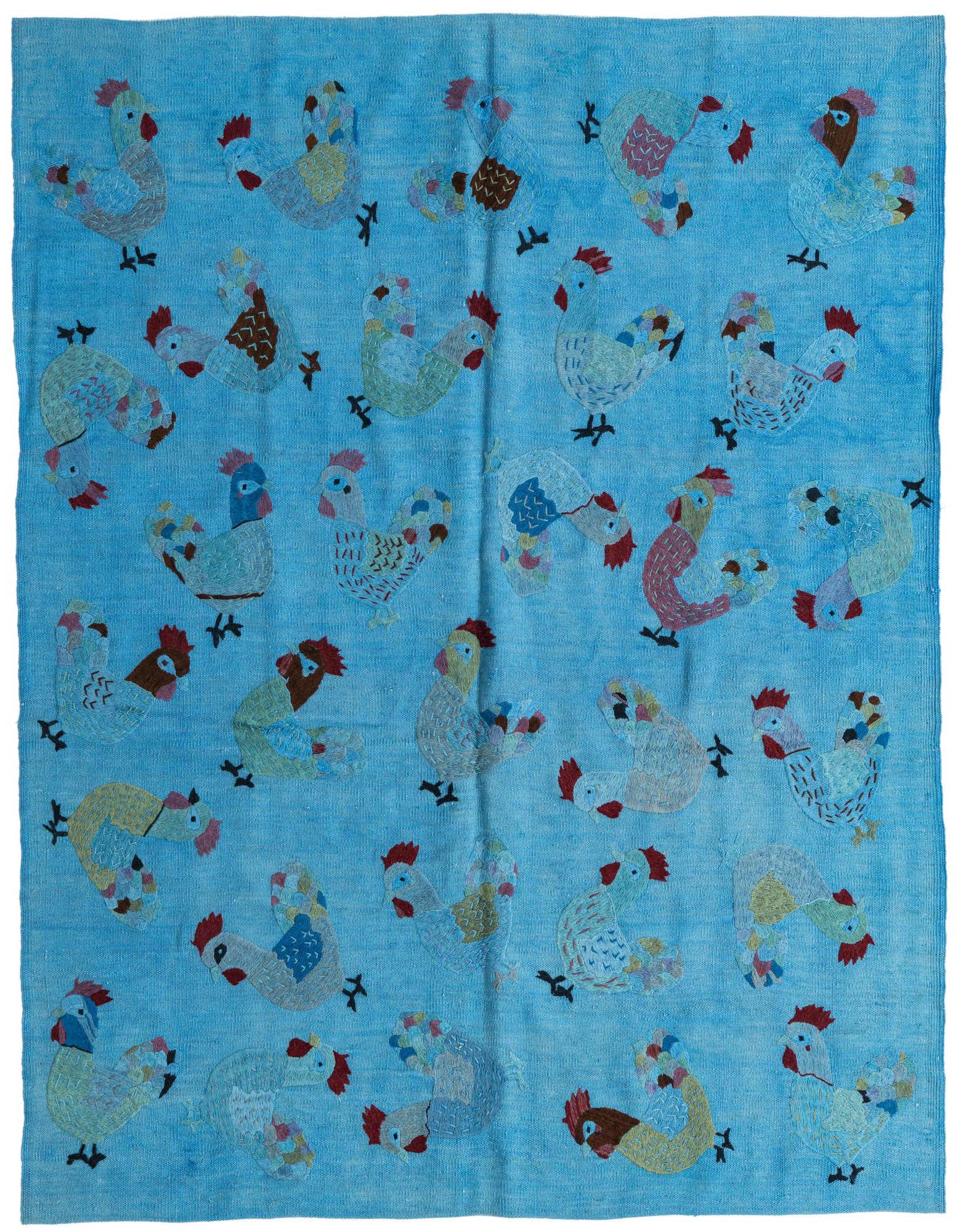 A 5x8 rectangular blue flatweave rug featuring a playful, repeating pattern of colorful tribal rooster motifs.