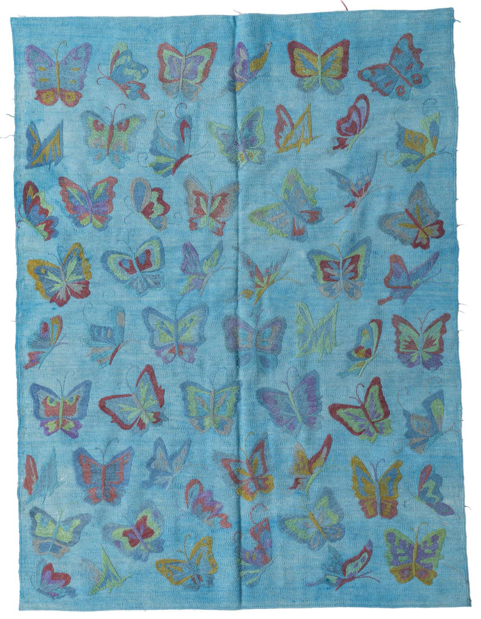 A 4x6 rectangular blue flatweave rug featuring a vibrant, scattered butterfly pattern in various colors.