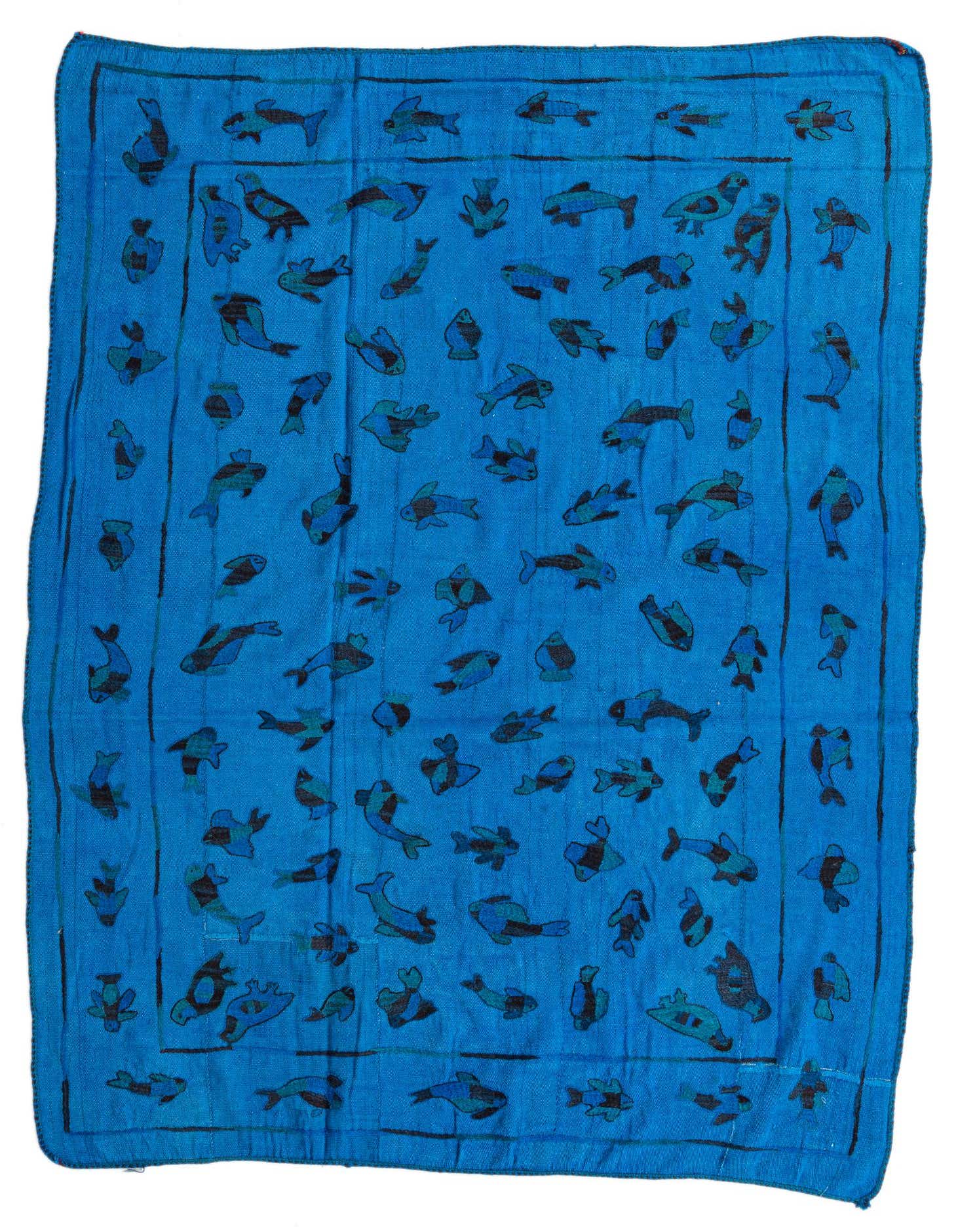 A 5x8 rectangular blue flatweave rug with a playful pattern of various fish in shades of blue and black.